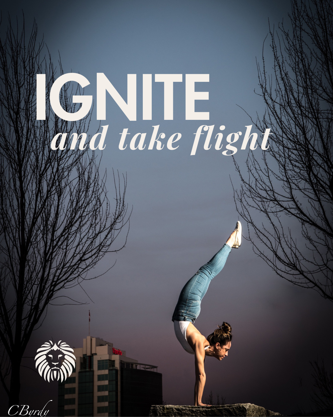 A woman performing a handspring yoga pose on a rock outdoors during dusk, with leafless trees and a tall building in the background, and the overlay text 'Ignite and take flight'.
