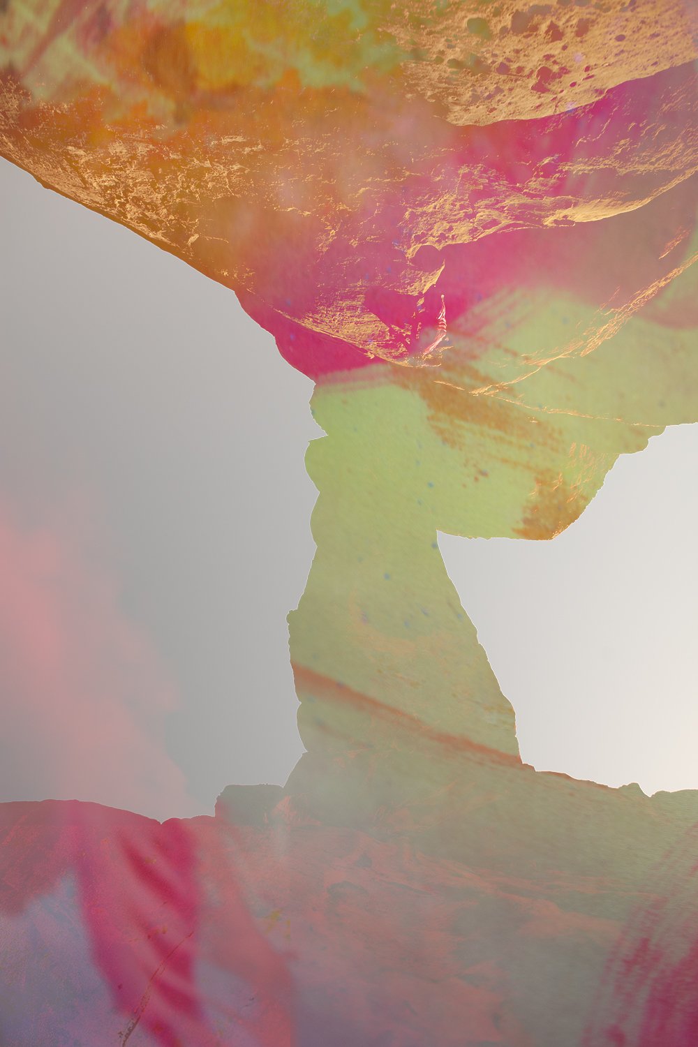 Abstract double exposure photo combining a landscape with rock formations and a silhouette of a person's face in profile by Faith-Ann Young