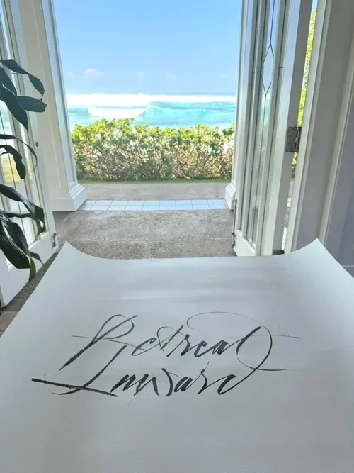 Calligraphy Retreat Inward with a backdrop of the ocean