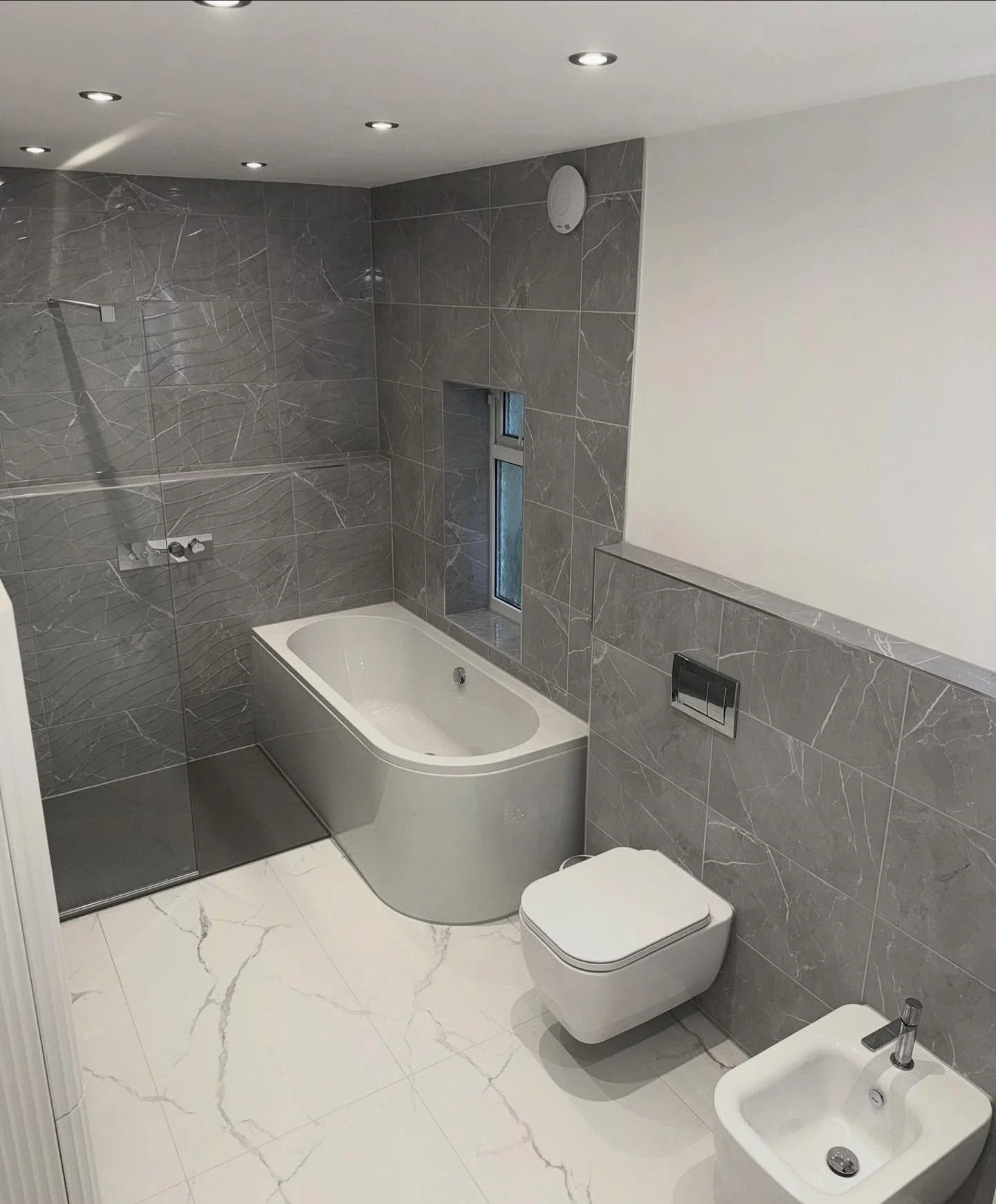 We recently transformed two small, individual rooms into one clean, spacious bathroom. By removing the awkward opening under the stairs and installing lintels to reposition the doorway, we created a far more accessible space which now features: 

Rai