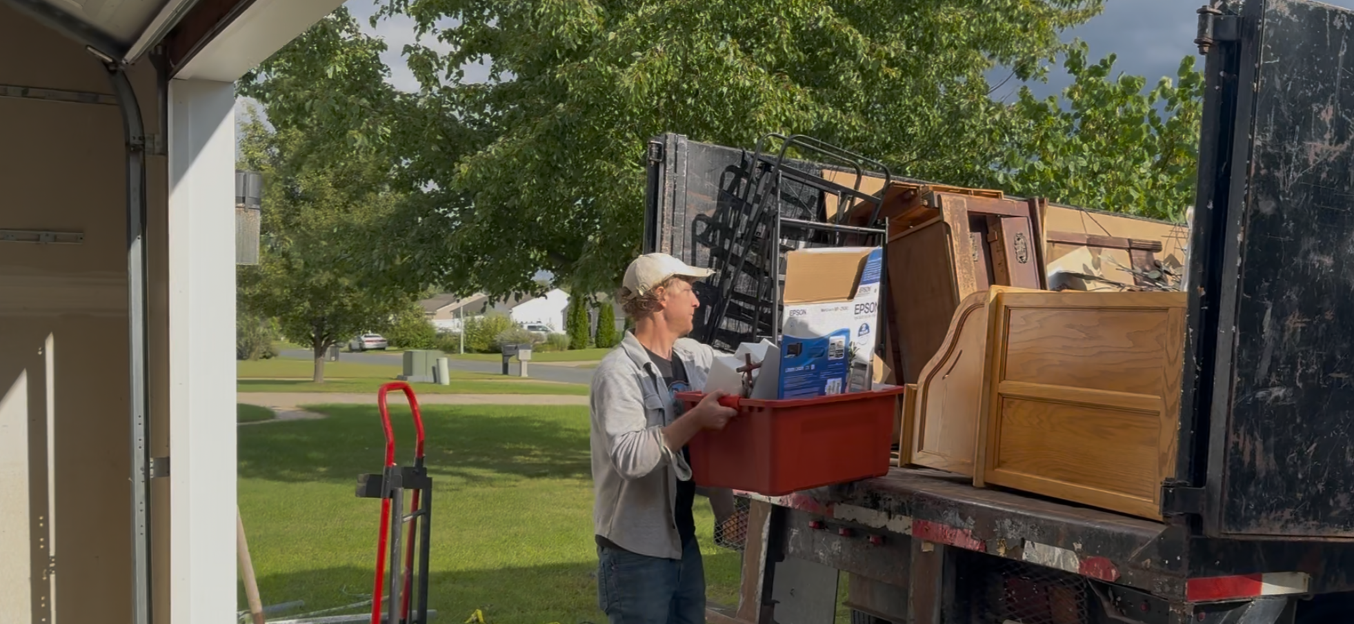 A junk removal worker cleaning out a garage for a customer