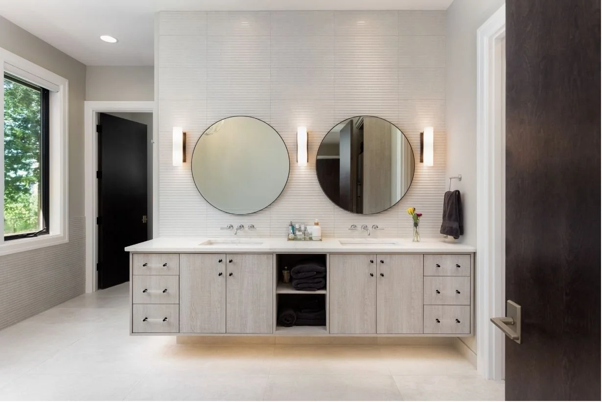Double vanity bathroom remodel idea for 2025 with stone features and natural hues.