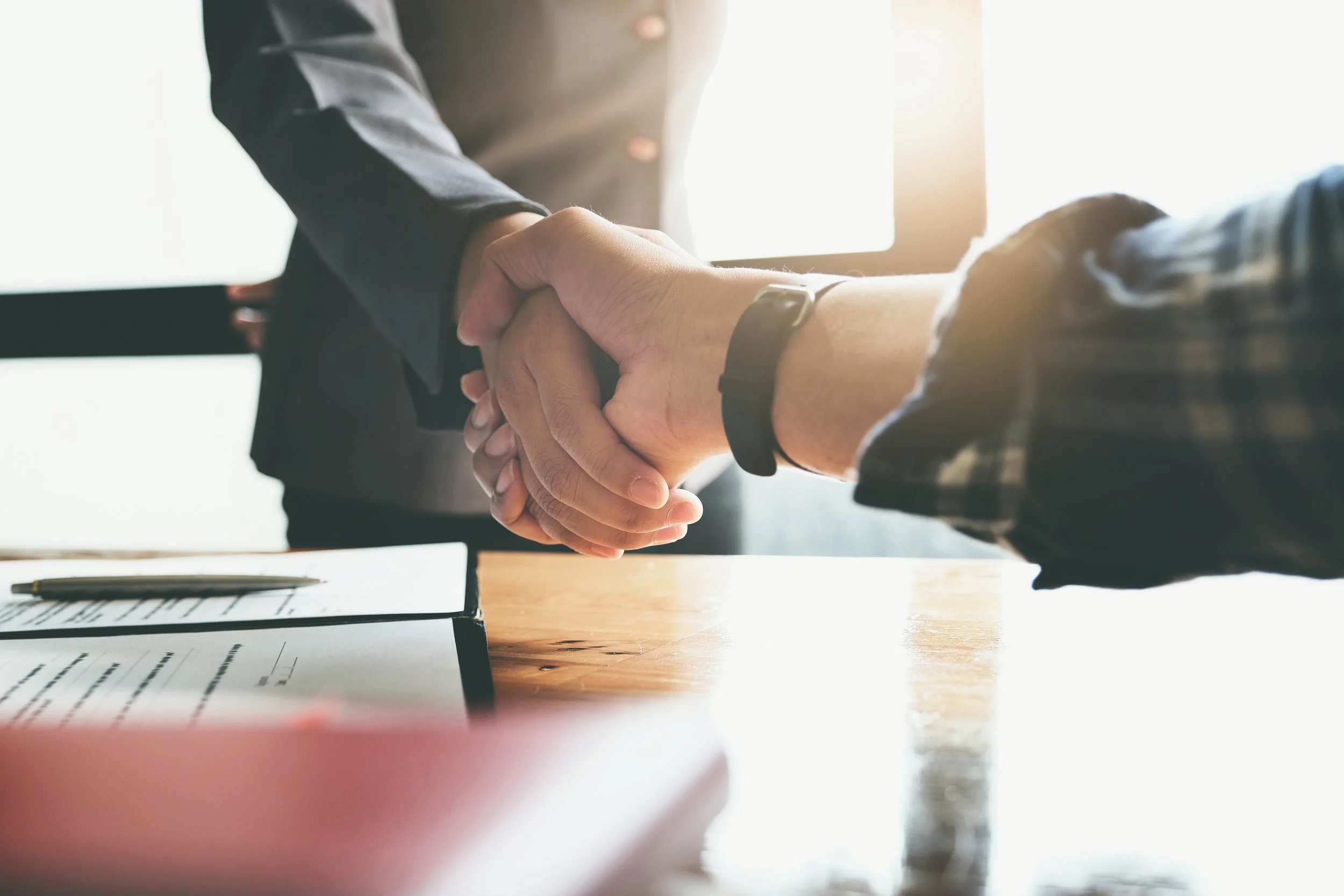 Focus on the congratulatory handshake.jpeg