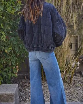 Woman wearing a black By Together Long Sleeve Quilted Knit Mineral Washed Jacket