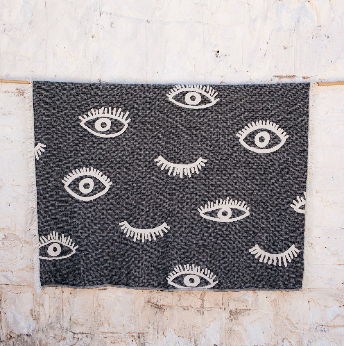 Evil Eye blanket hanging on a line