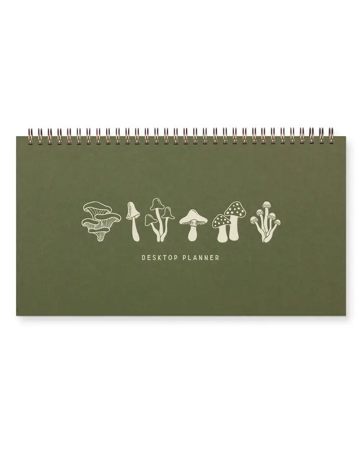 A green planner with mushrooms on the cover