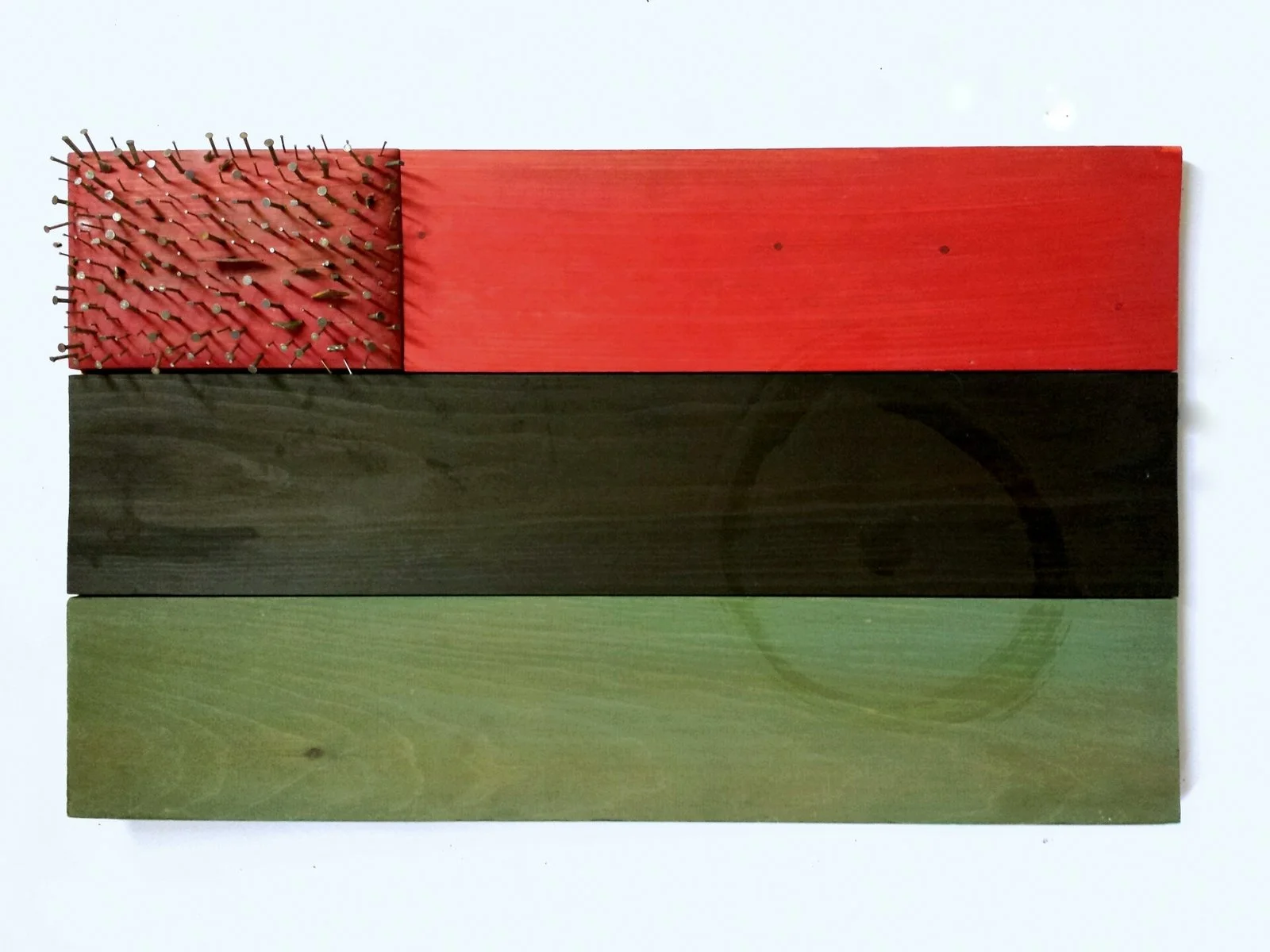 red black and green panels, looks like flag with nails for the stars