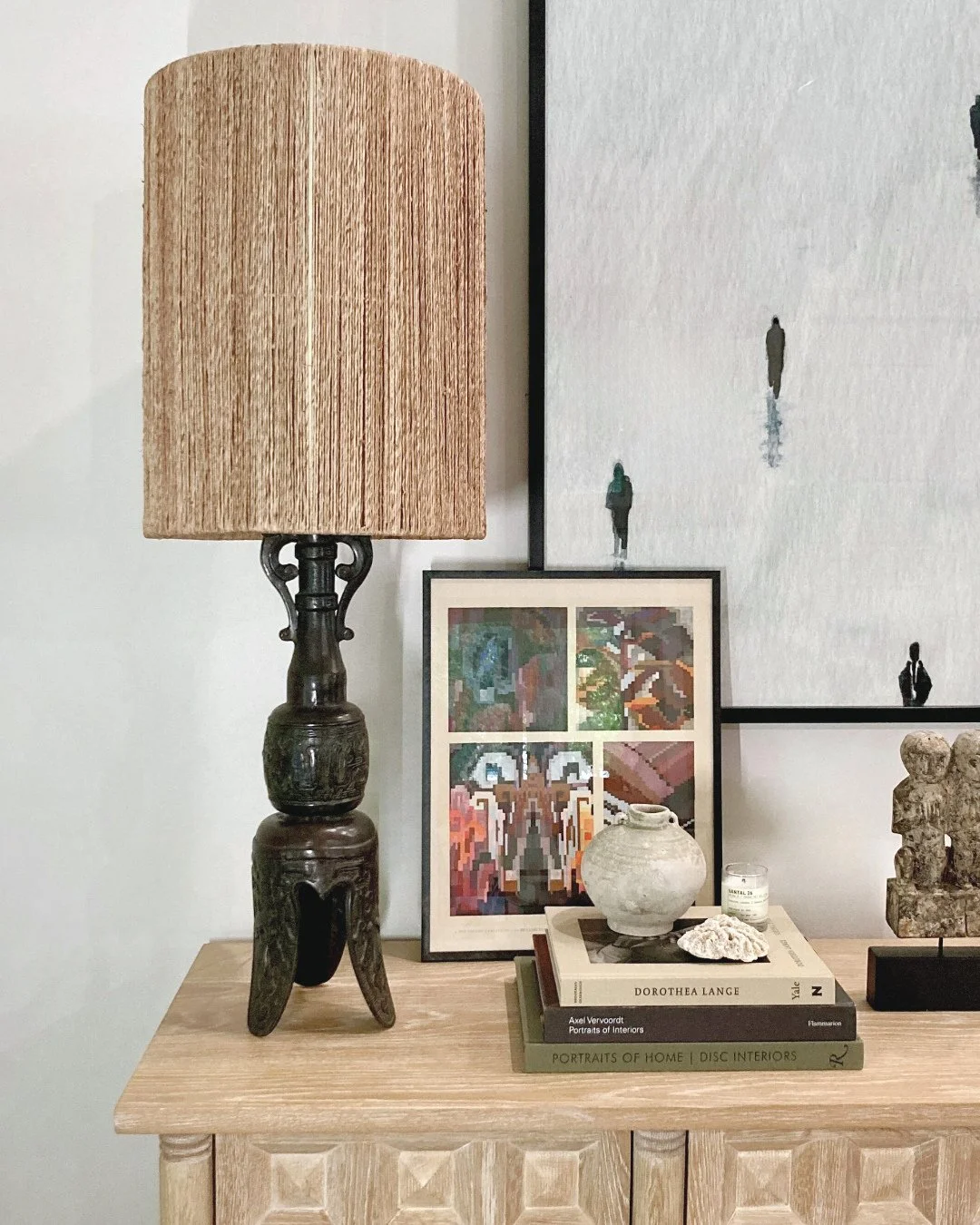 A little corner of our home: a bronze lamp from my husband's childhood in Hong Kong, a vessel found underwater in Bali, a piece of coral from St. Lucia, a favorite Le Labo candle, and books that shift with the mood. Layered among them, a framed fragm
