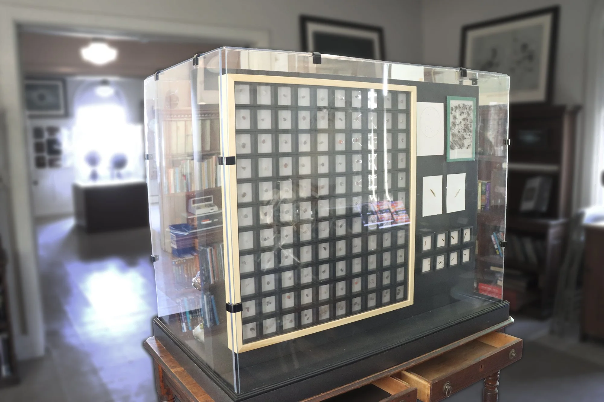 BackSide of case with astronomically inspired works. Exhibition View.