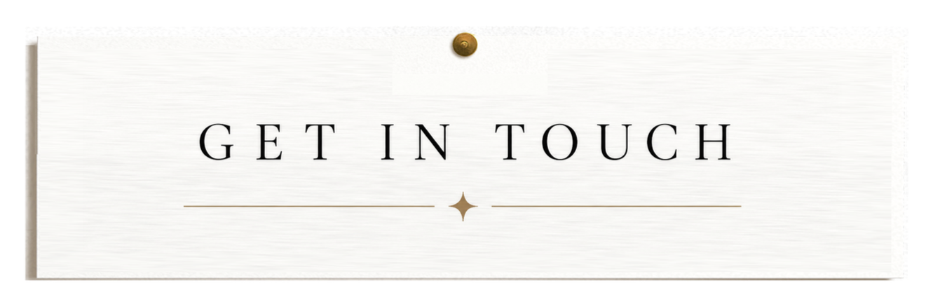A white sign with black text reading 'GET IN TOUCH' and decorative gold lines and star, pinned on a white wall.