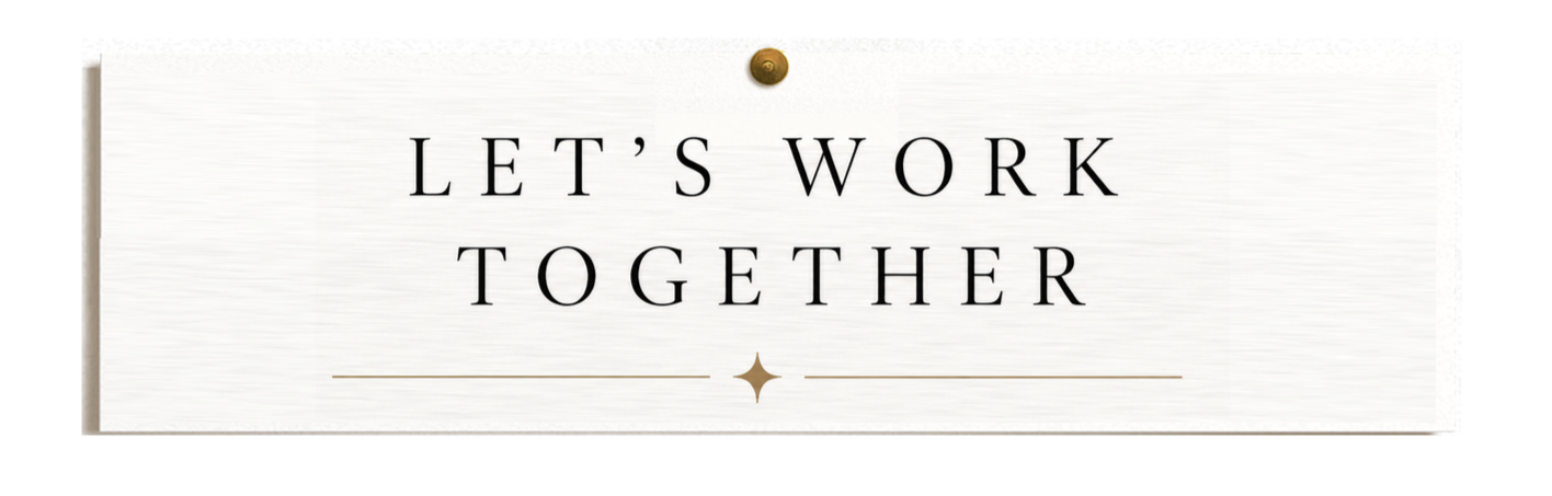 A white sign with the text 'Let's work together' in black capital letters, pinned above with a gold pin.