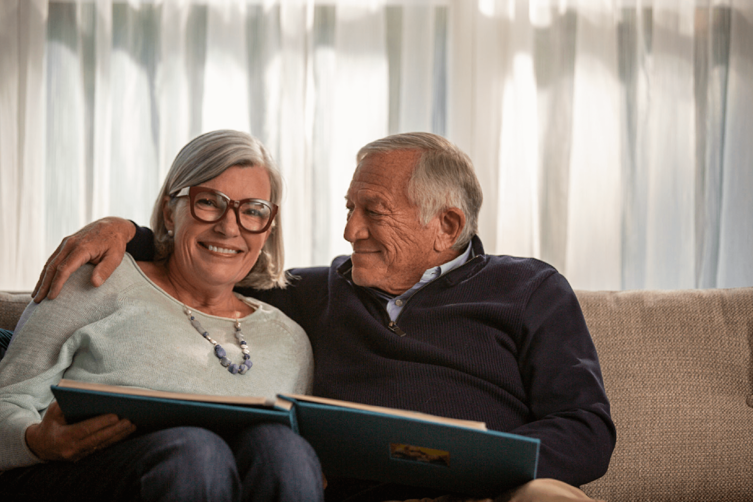 work_lifestyle-retired-couple-reminiscing-on-couch-5.png