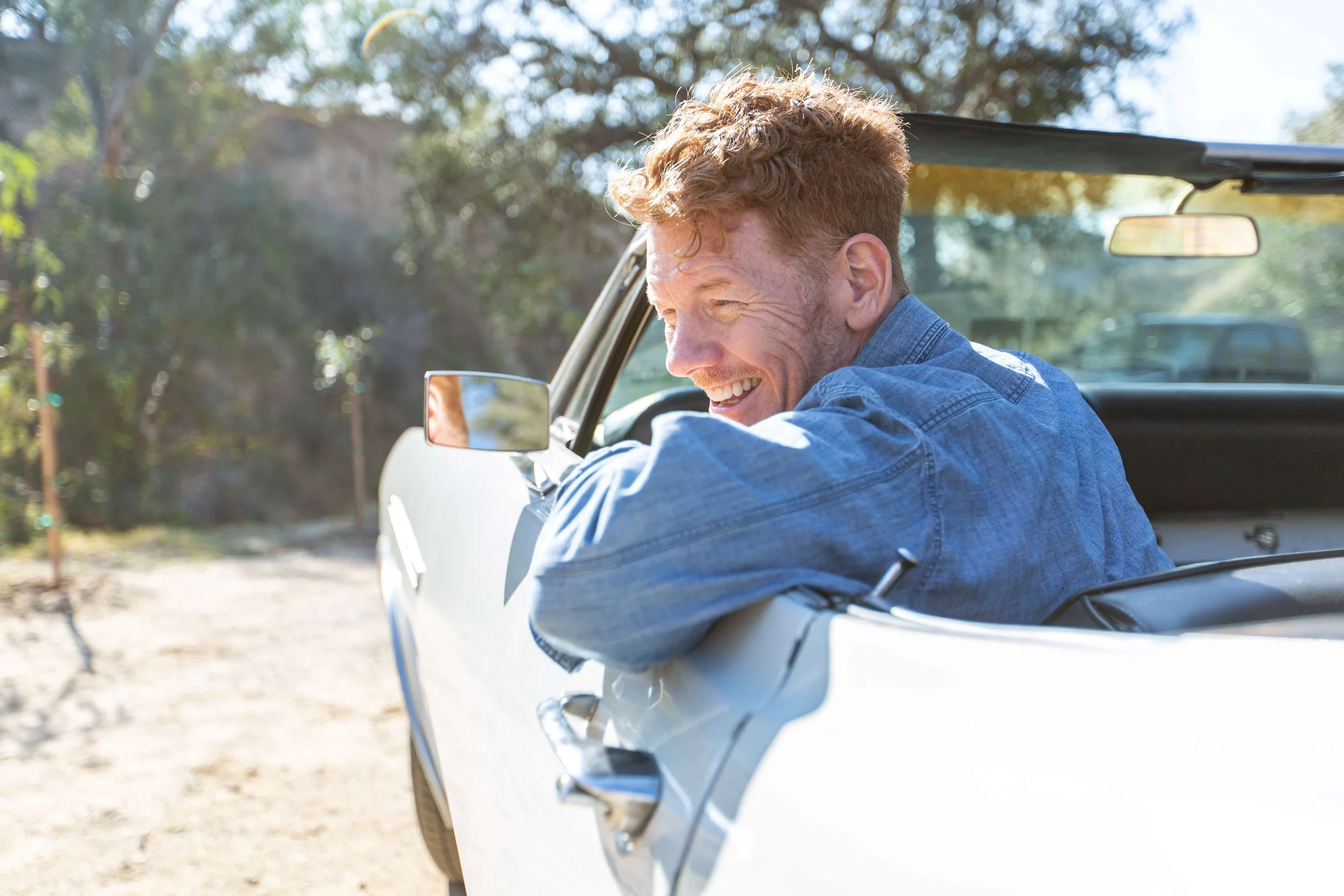 work_lifestyle-man-soaking-up-scenic-drive-in-classic-convertible-car-6.jpg
