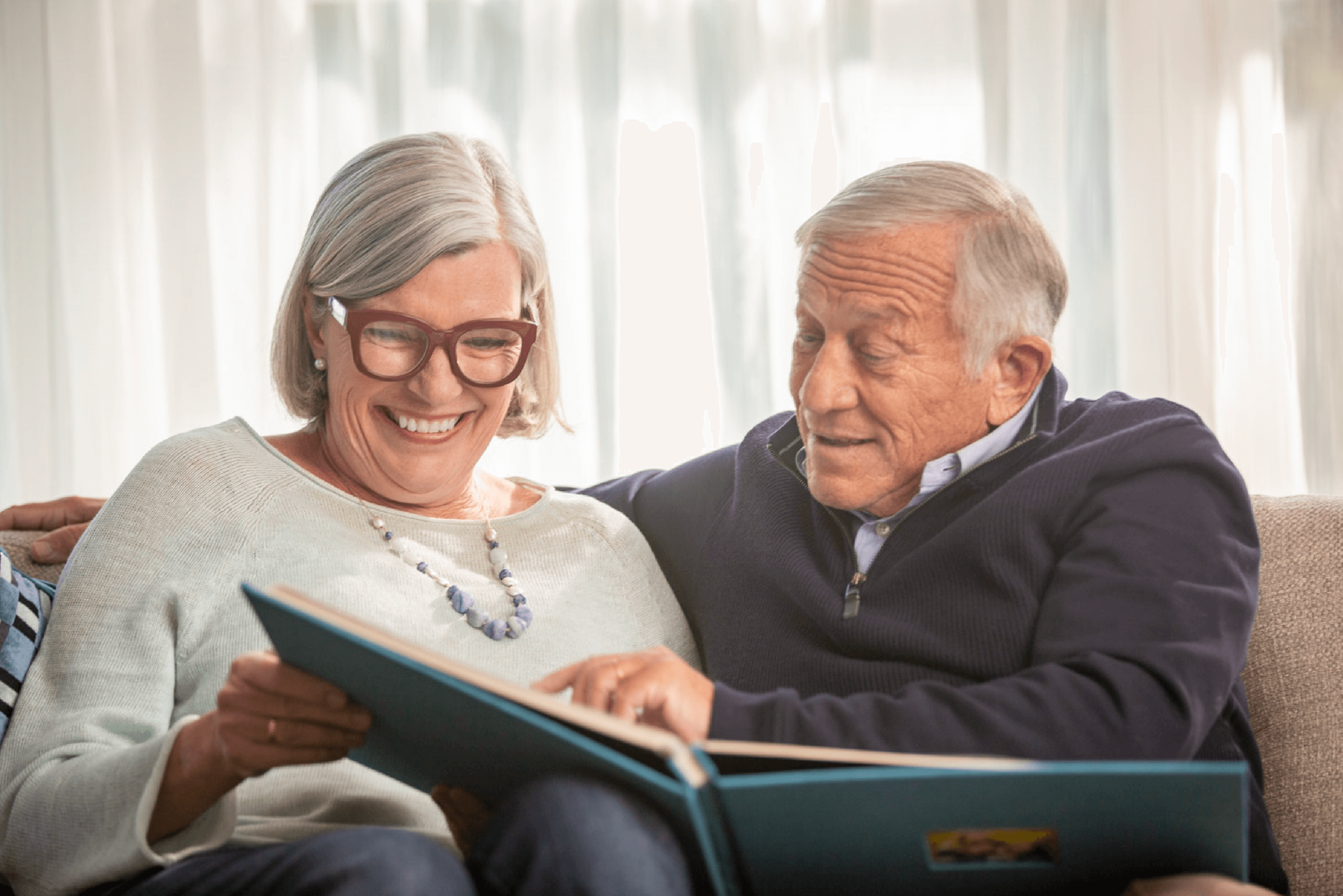 work_lifestyle-retired-couple-reminiscing-on-couch-3.png