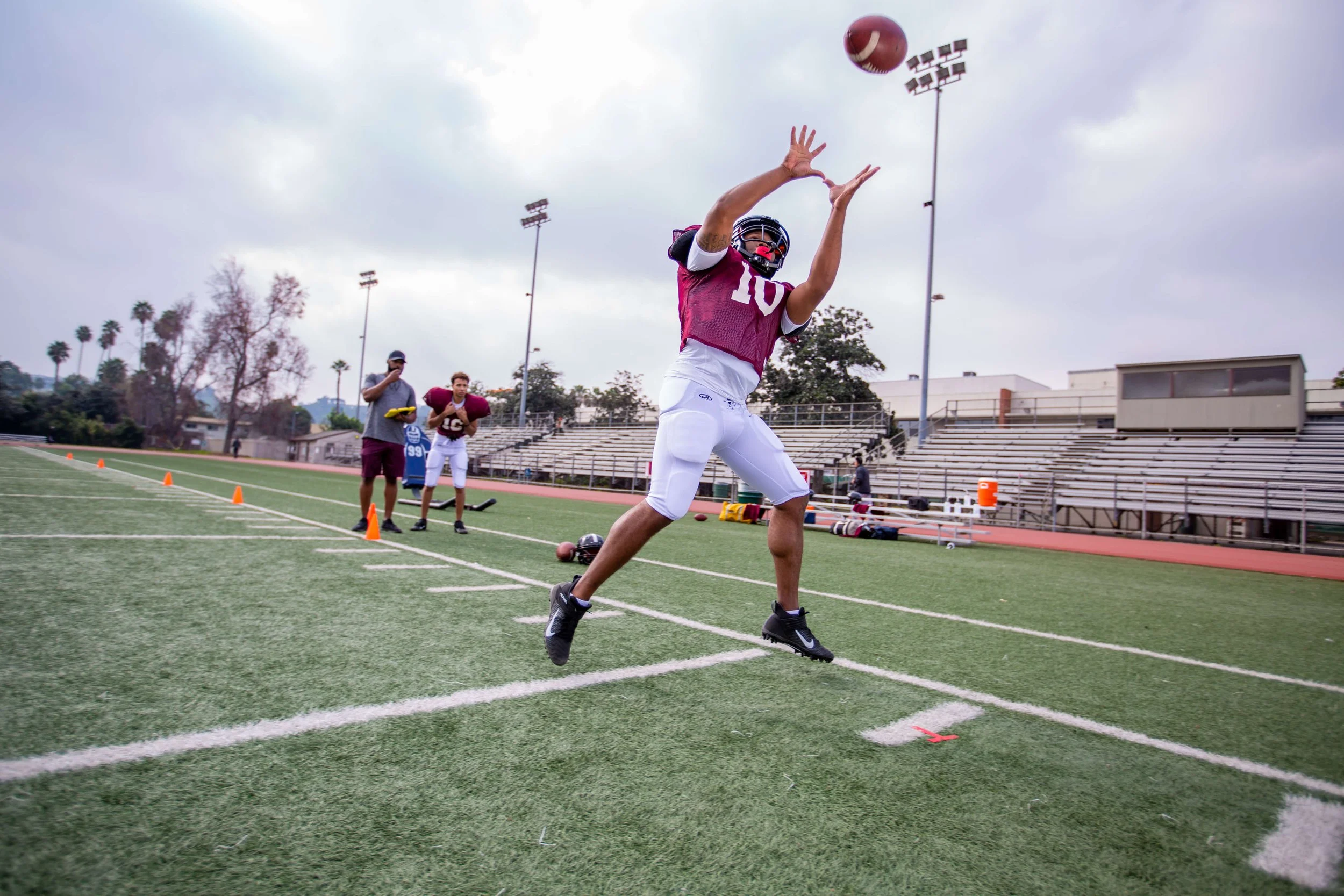 work_lifestyle-football-athlete-catching-pass-along-sideline-1.jpg