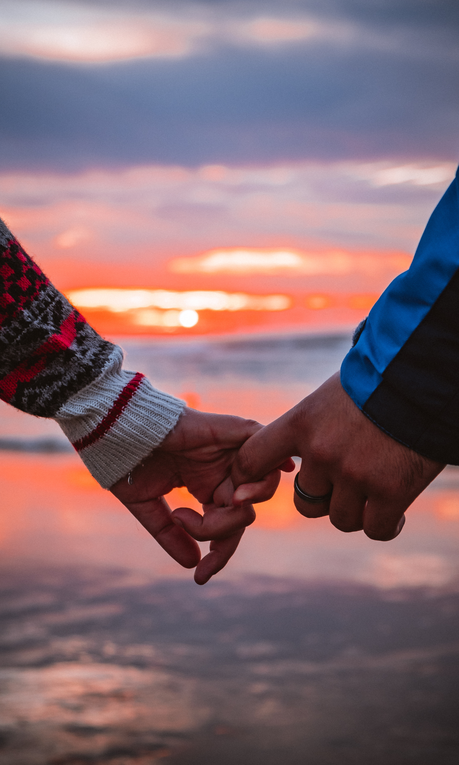 A couple holding hands and watching the sunset after attending a session for couples counselling in Ottawa
