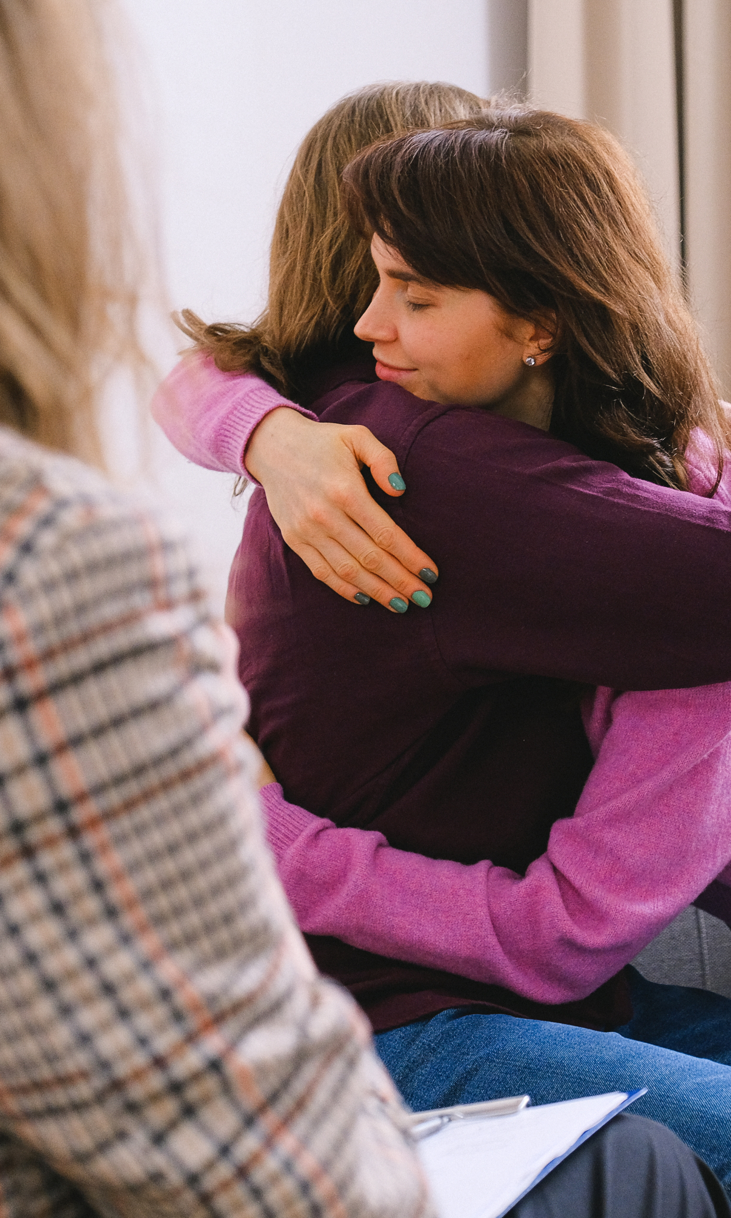 A therapist giving her client a hug after a session in Ottawa