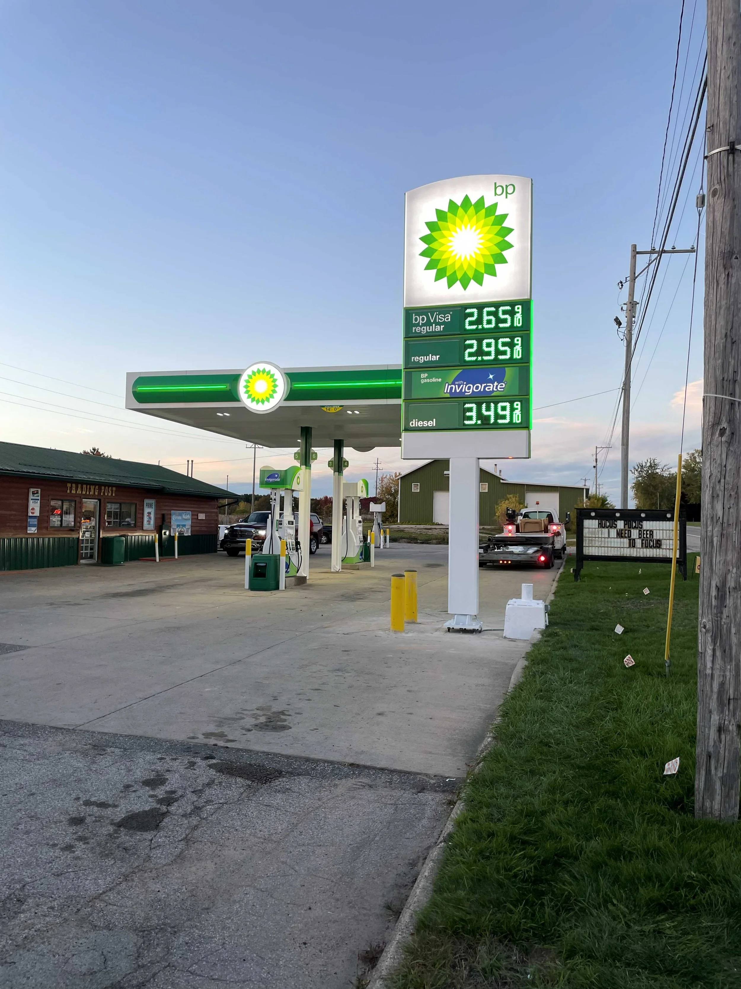 LED digital fuel price sign at a BP gas station displaying regular, plus, and diesel prices, example of petroleum commercial signage.