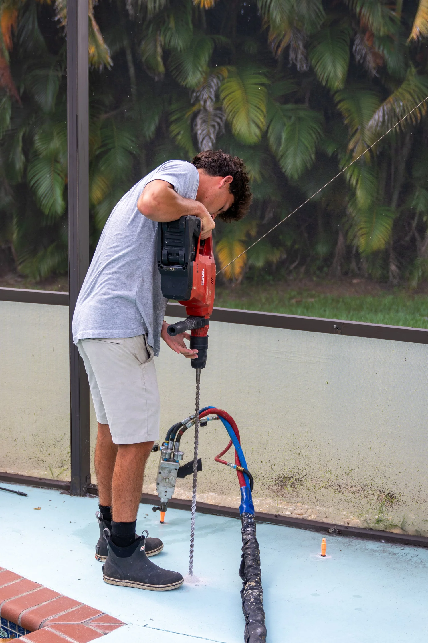 Drilling small injection holes for concrete lifting and stabilization in Florida