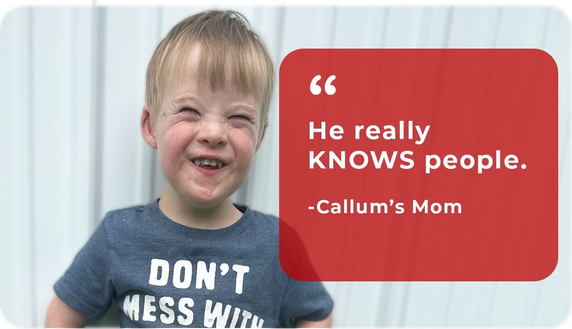 A young boy with red hair and a big smile, wearing a navy blue t-shirt that says "Don't Mess With" with the rest of the words cut off. Standing in front of a light-colored wall with vertical paneling. There is a red speech bubble with white text that reads ""He really KNOWS people." - Callum's Mom.