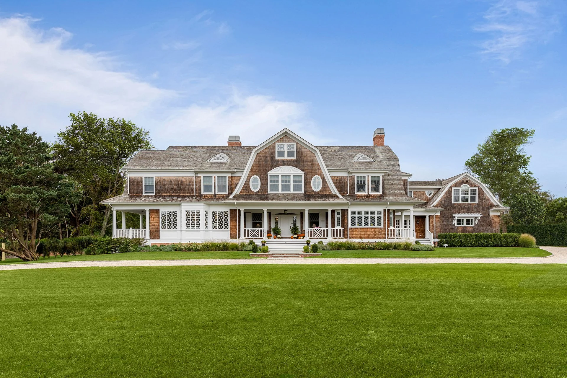 Large, historic home renovation with cedar shingle siding, custom windows and doors finished with beautiful landscaping