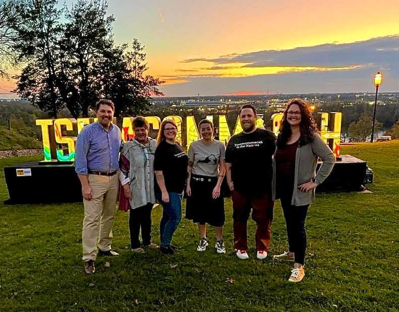 Pamunkey citizens, VNAA founders and former Pamunkey Cultural Resource Director, Shaleigh Howells stand in front of the Tsenacommacah installation in Libby Hill Park.