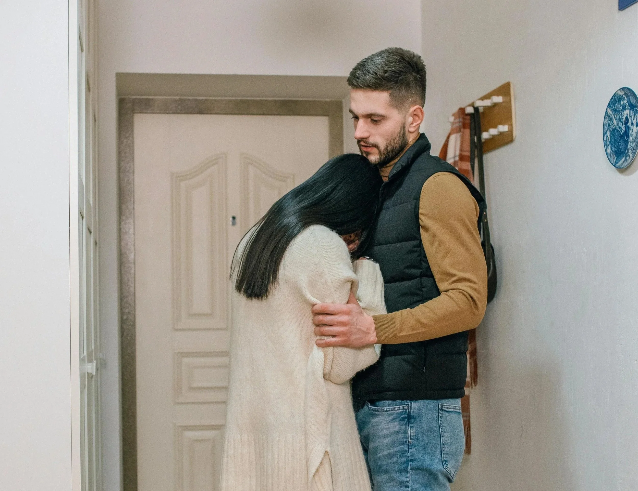 a mand and women holding each other while women is distraught