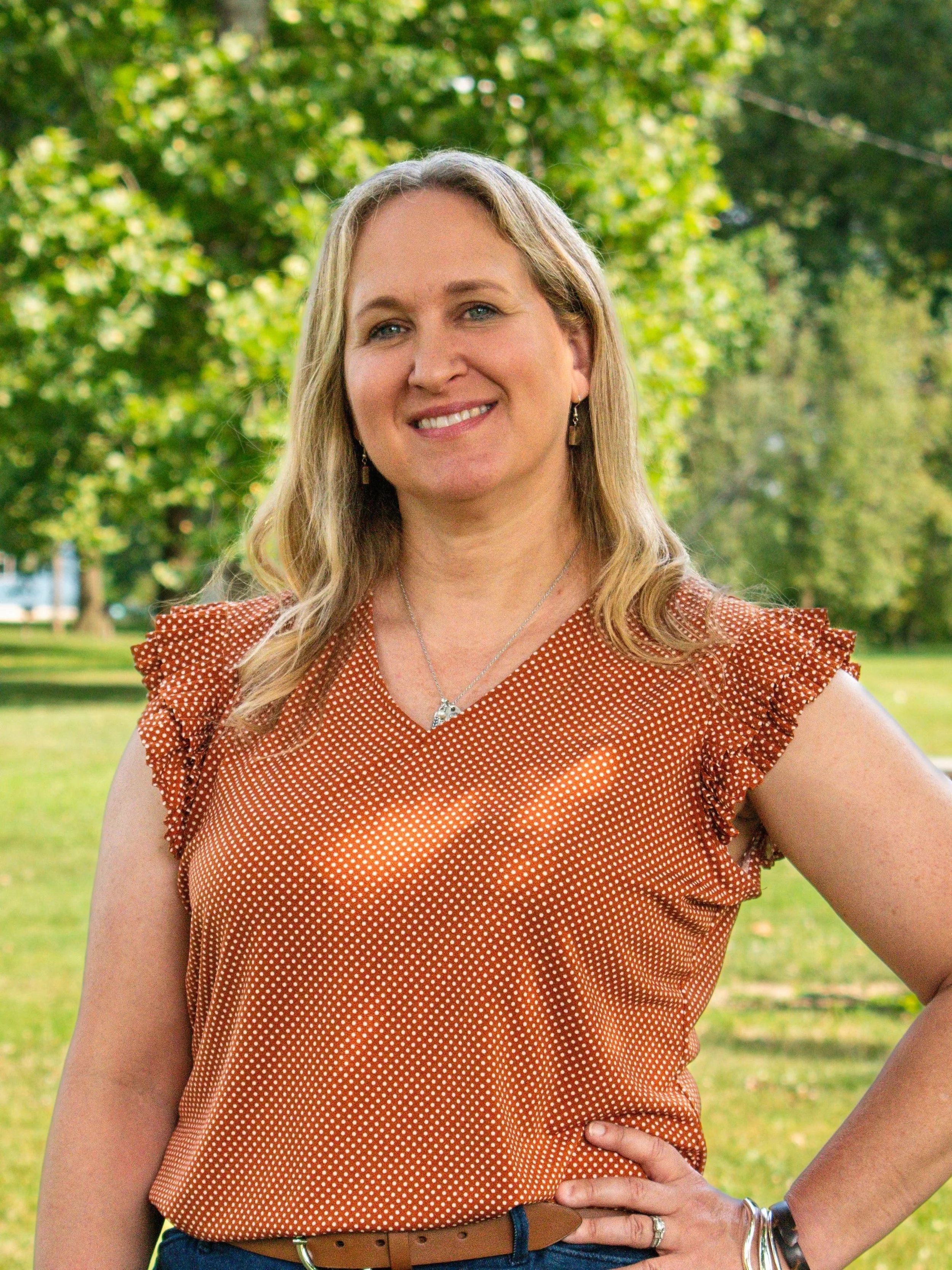 Portrait of Sara Floreth, outside with trees in the background