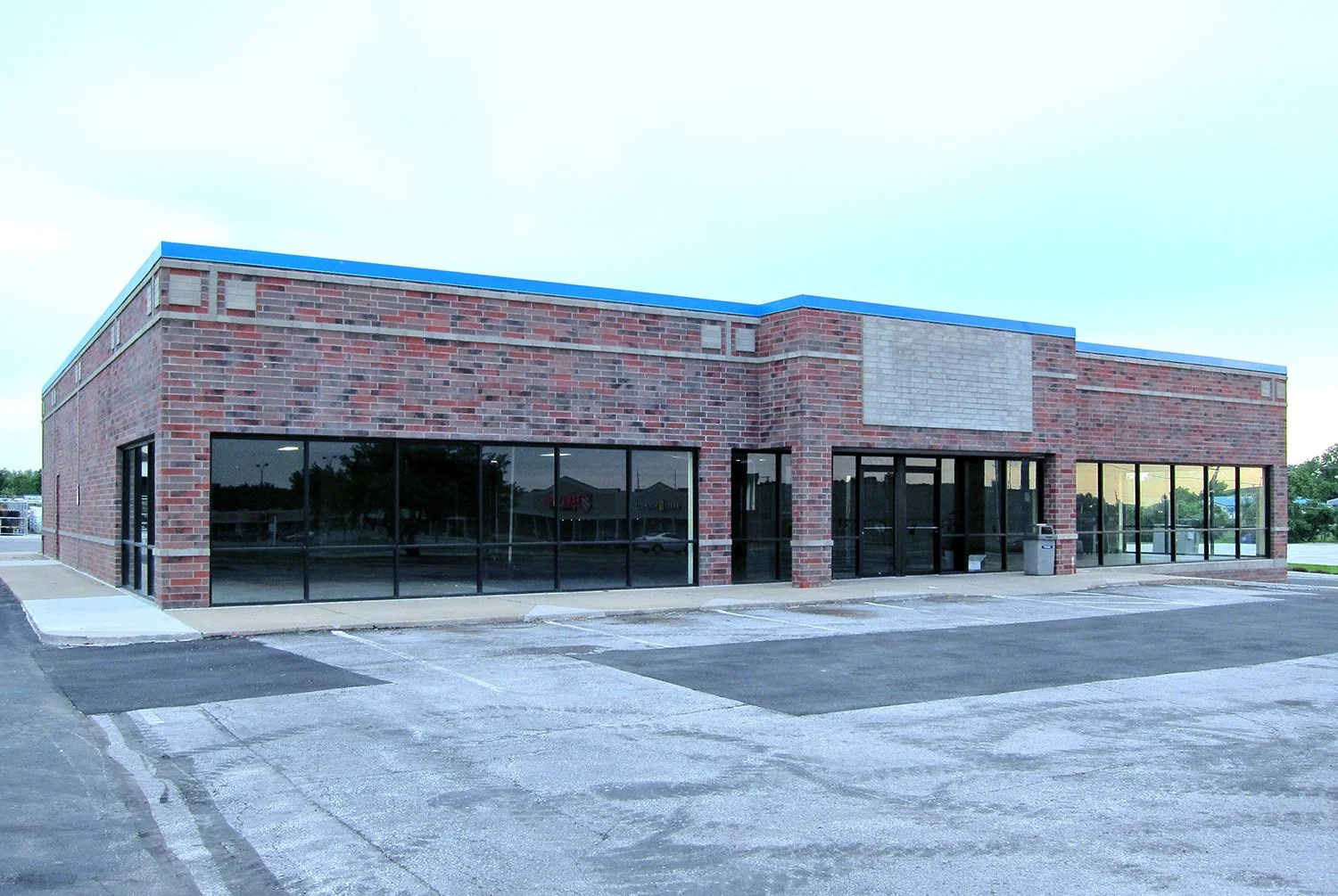A BlockBuster video rental store that has been closed and stripped out. Located in the American Midwest, this purposefully-built store is an example of a BlockBuster building design from the '90s.