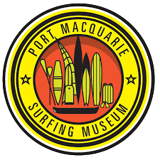 Logo of the Port Macquarie Surfing Museum featuring a yellow border, surfing-related imagery, and the museum's name.