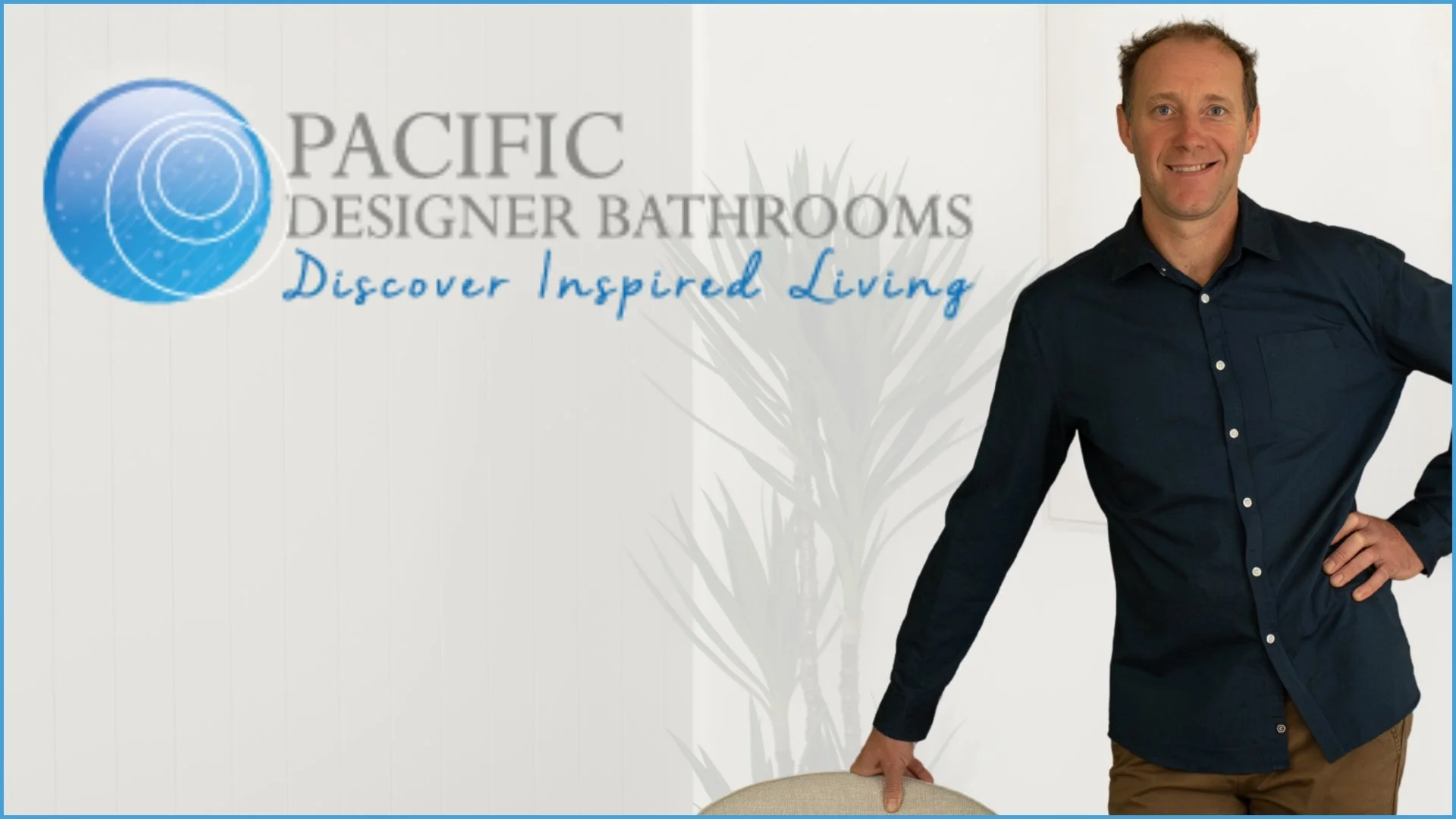 Logo of Pacific Designer Bathrooms with slogan 'Discover Inspired Living' on a background of a bathroom interior with a vanity and plants.