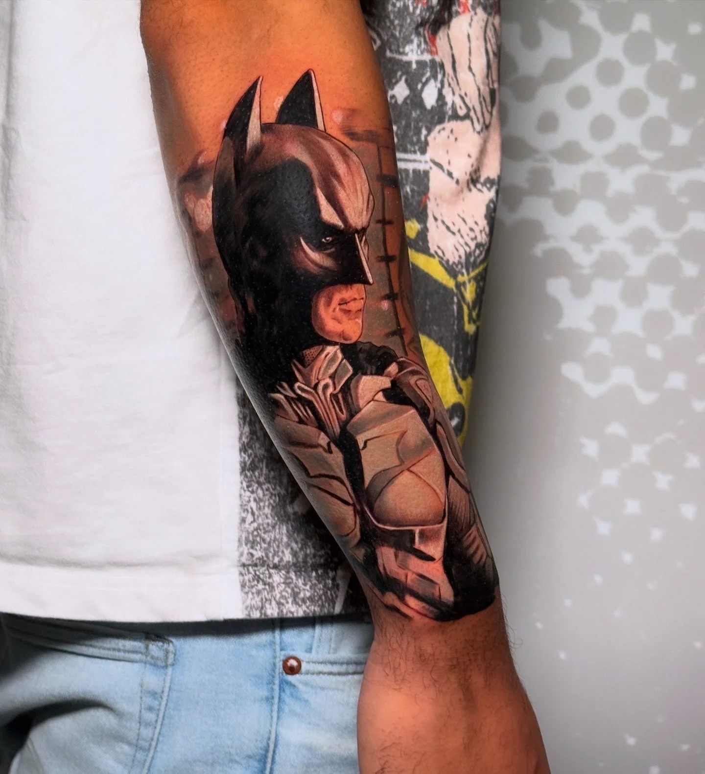 A detailed tattoo of Wolverine from Marvel comics on a person's forearm, depicting his fierce expression and iconic costume.