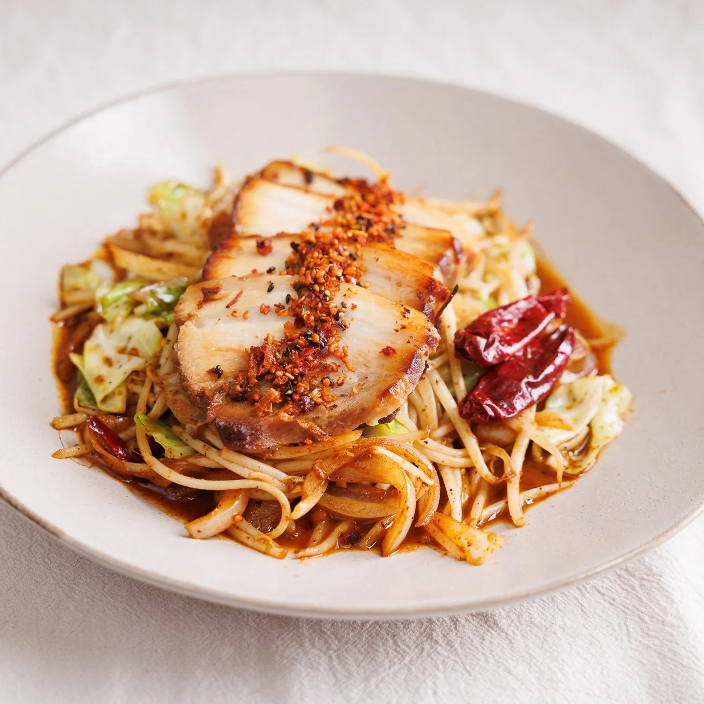 Take a look at this fan favorite: Devil Chashu. 🔥 Tender, melt-in-your-mouth pork belly topped with a kick of spice and served over a bed of savory saut&eacute;ed cabbage and sprouts. It&rsquo;s the ultimate bold appetizer to kick off your ramen jou