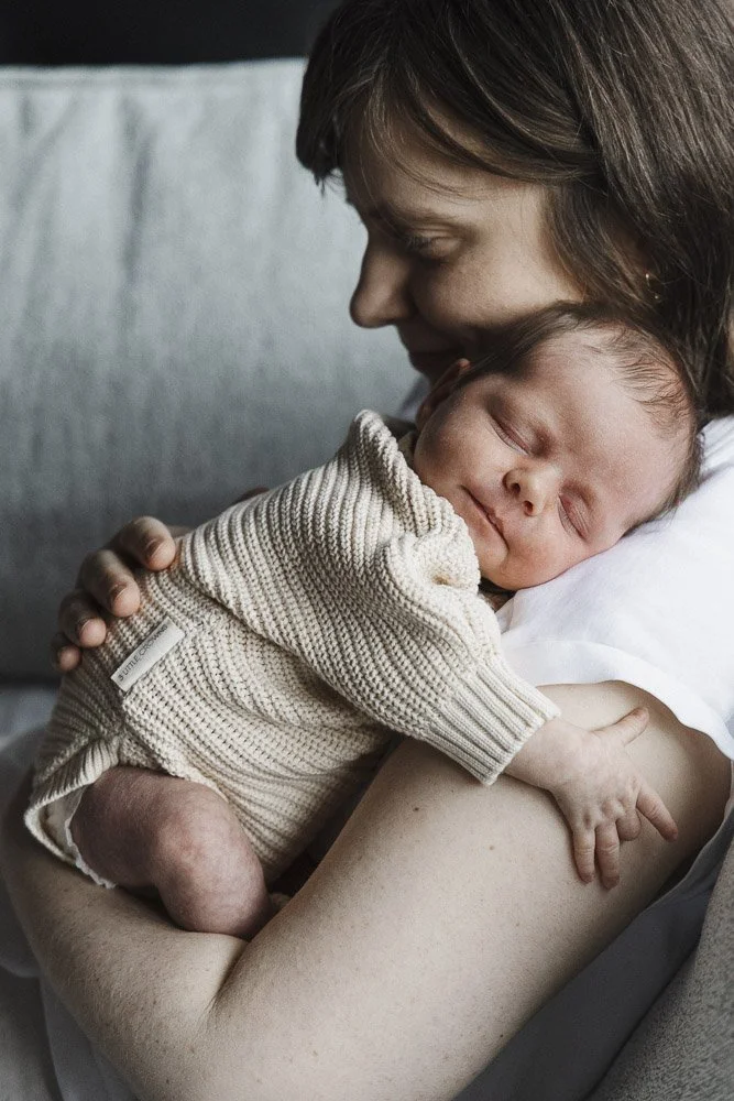 Mother holding newborn baby in her arms 