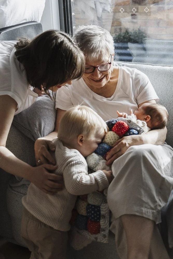 grandomother, mother, son and newborn son together in family portrait