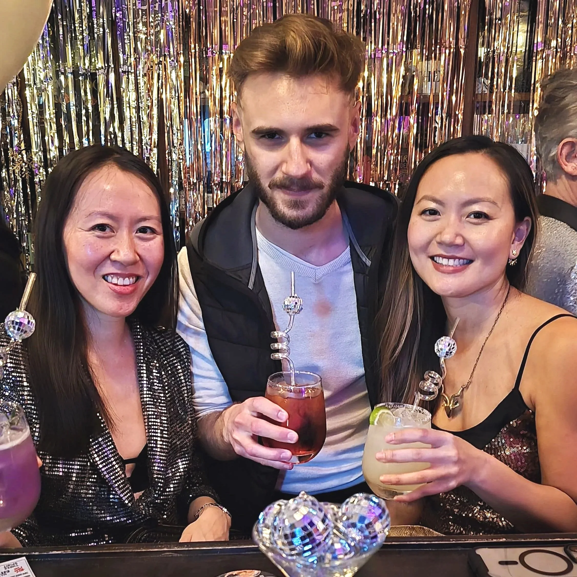 Three people enjoying non-alcoholic drinks at New Years party.