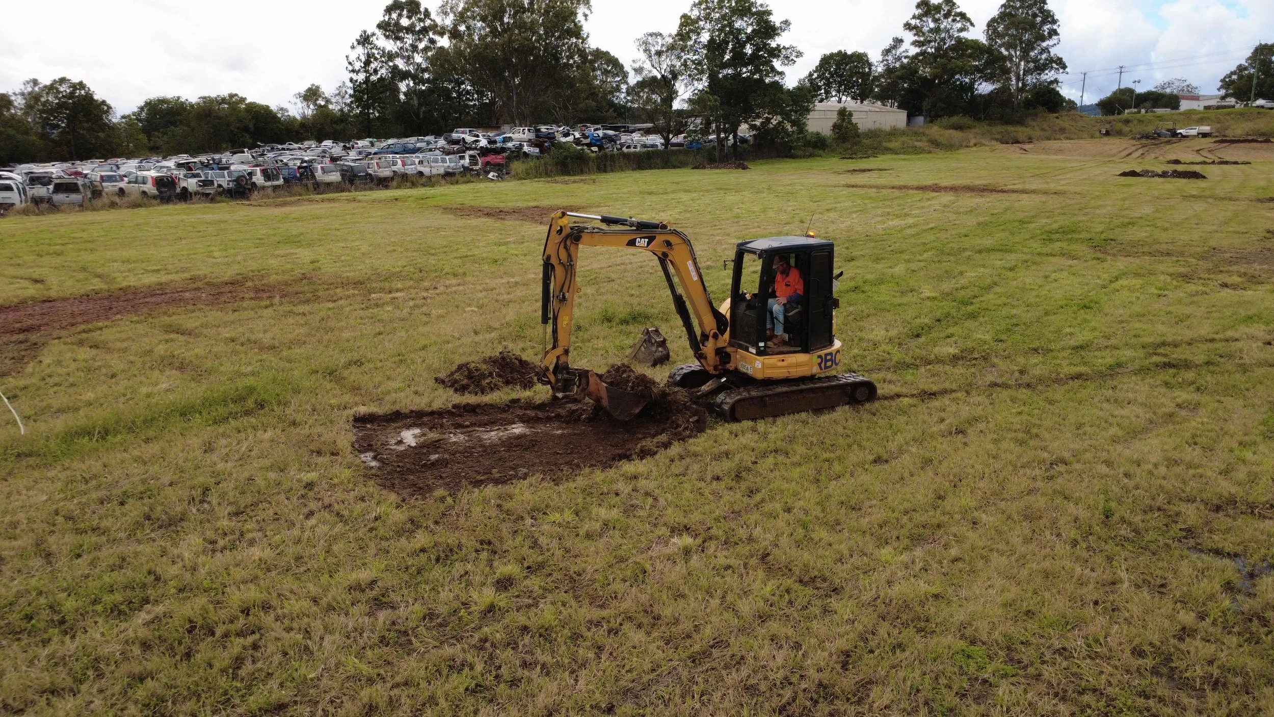 Excavator doing detailed site investigation digging for contamination at a construction site