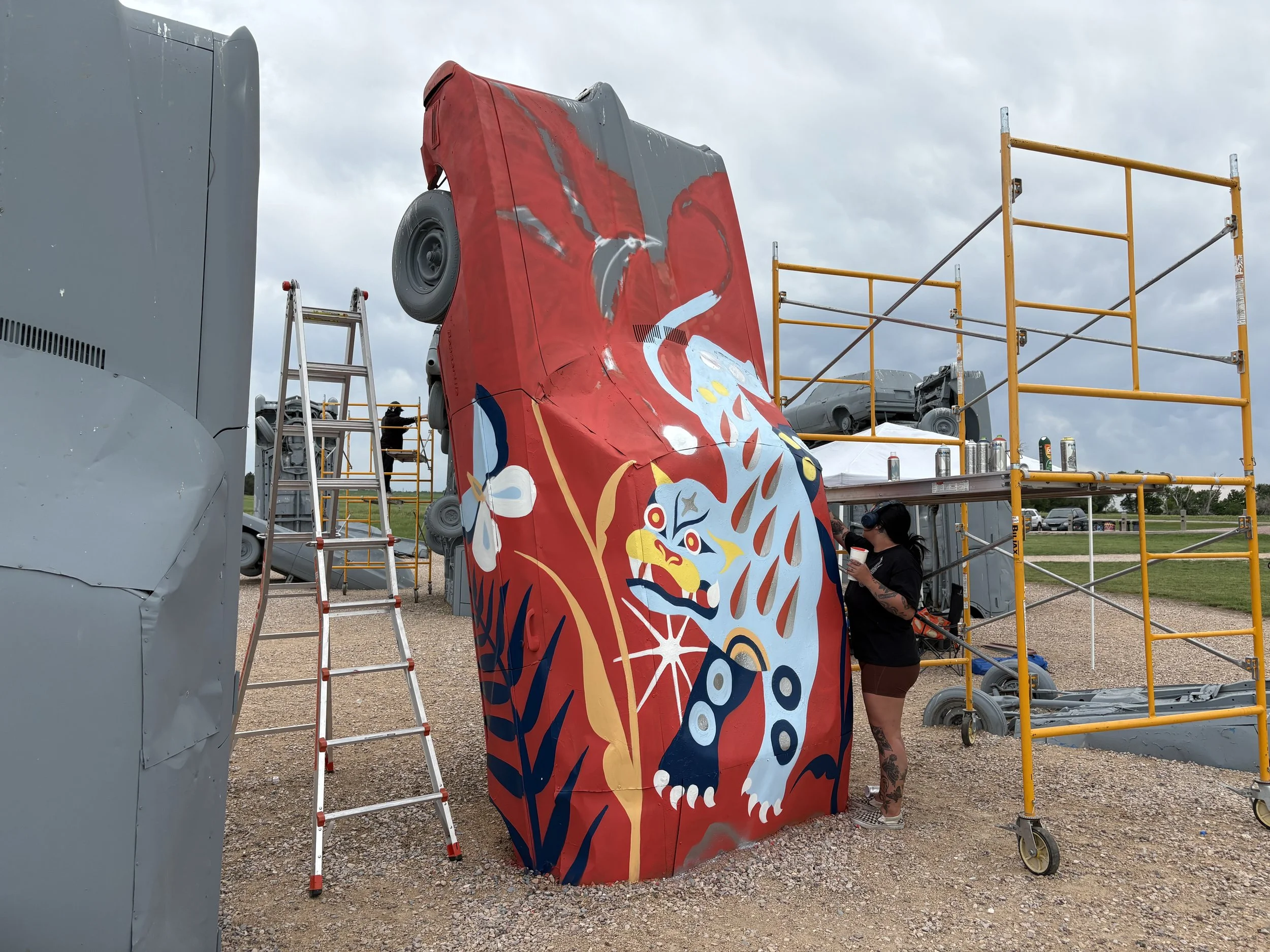 Artist Stevie Shao working on the first carhenge murals street art