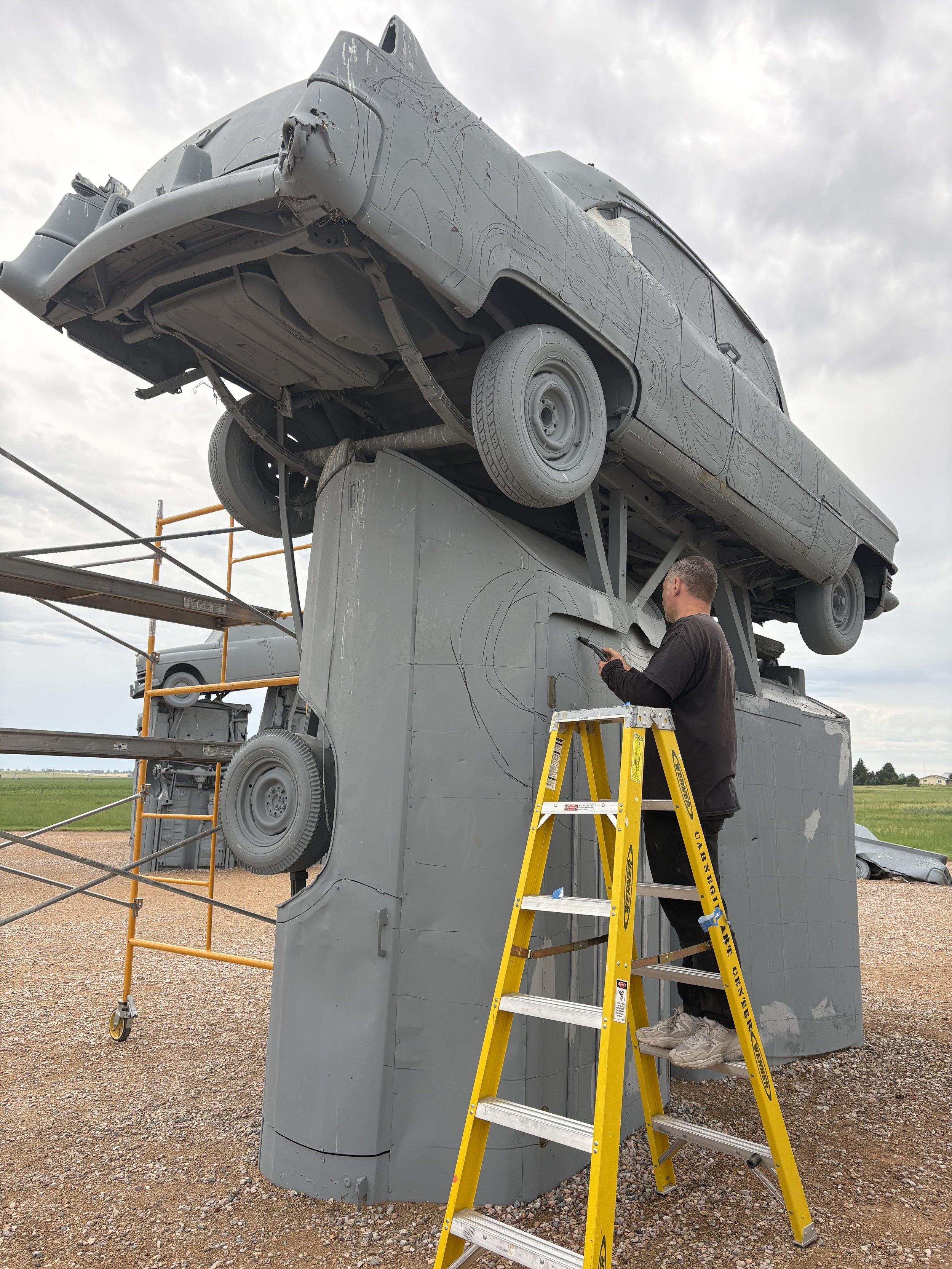 Artist Key Detail painting one of the first carhenge murals, street art