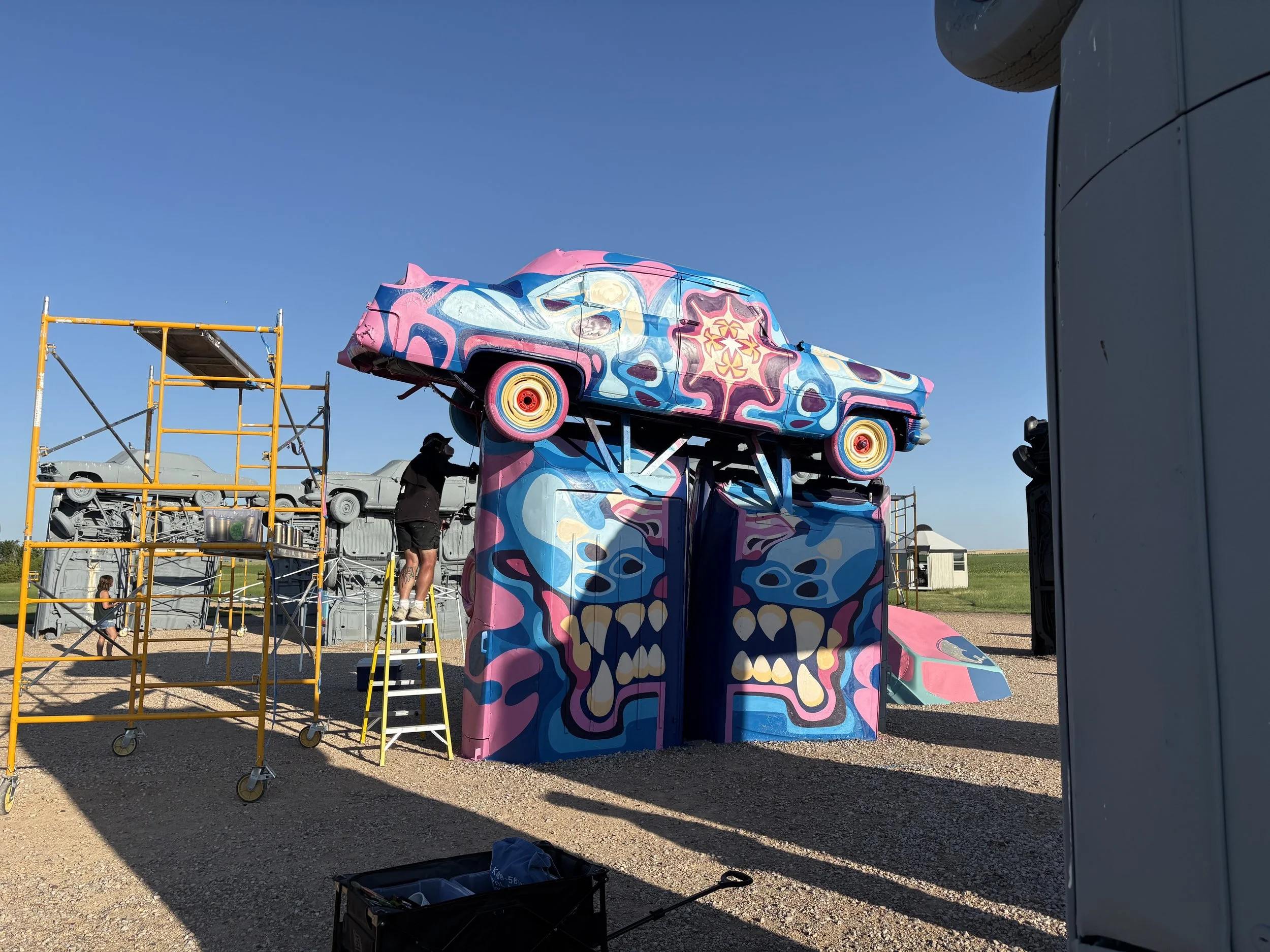 Street art. Artist Key Detail painting a mural at carhenge