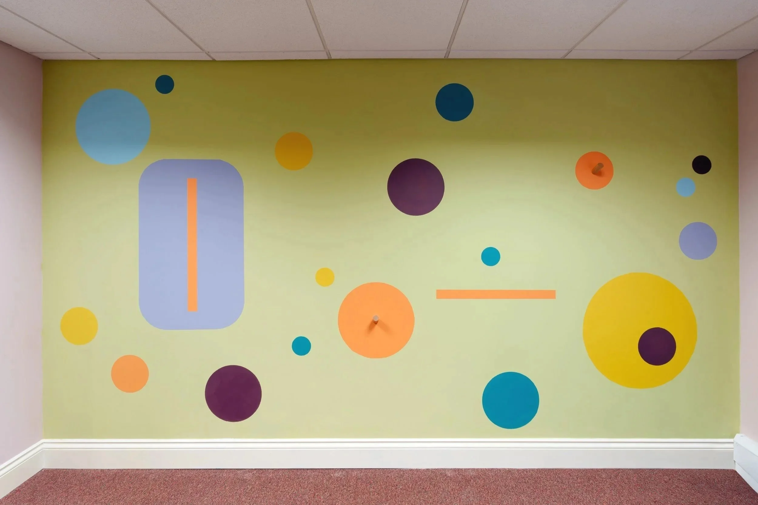 Wall painting using a polka dot design in the games room at St Andrew’s Children’s Society in Leith, Edinburgh