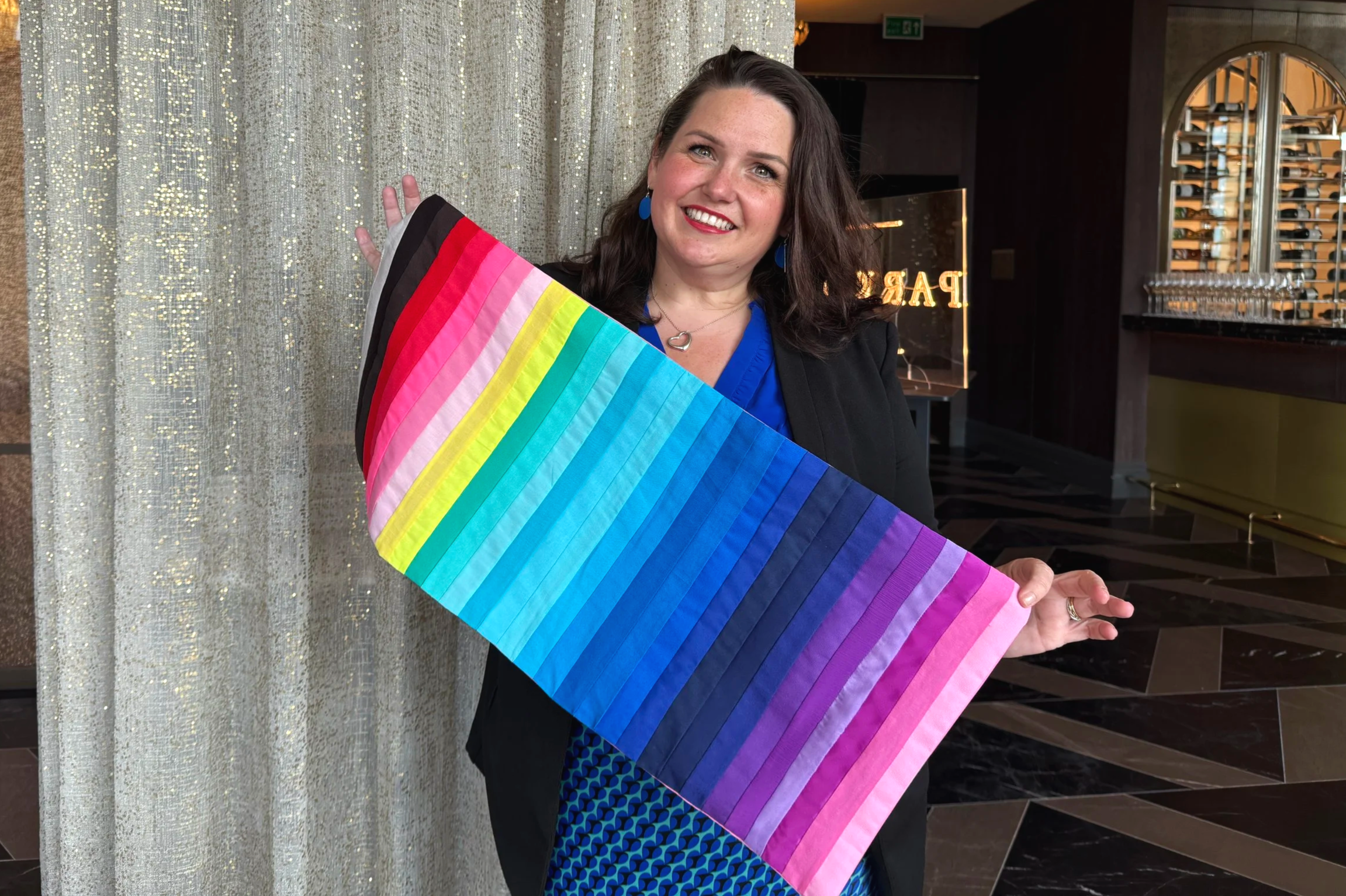 Lucy, an image consultant, holding a full spectrum colour drape during a colour analysis session, showing how different shades interact with natural colouring to support confident personal style.