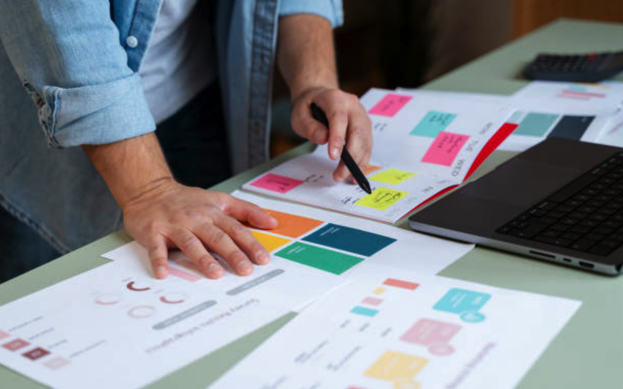 Man standing over investor pitch deck that he's working on