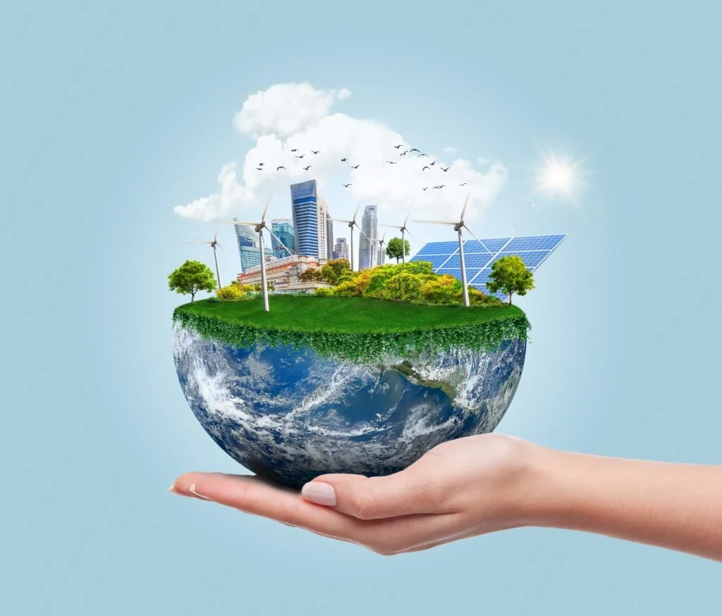 Hand holding planet earth with clean modern city relying on renewable resources