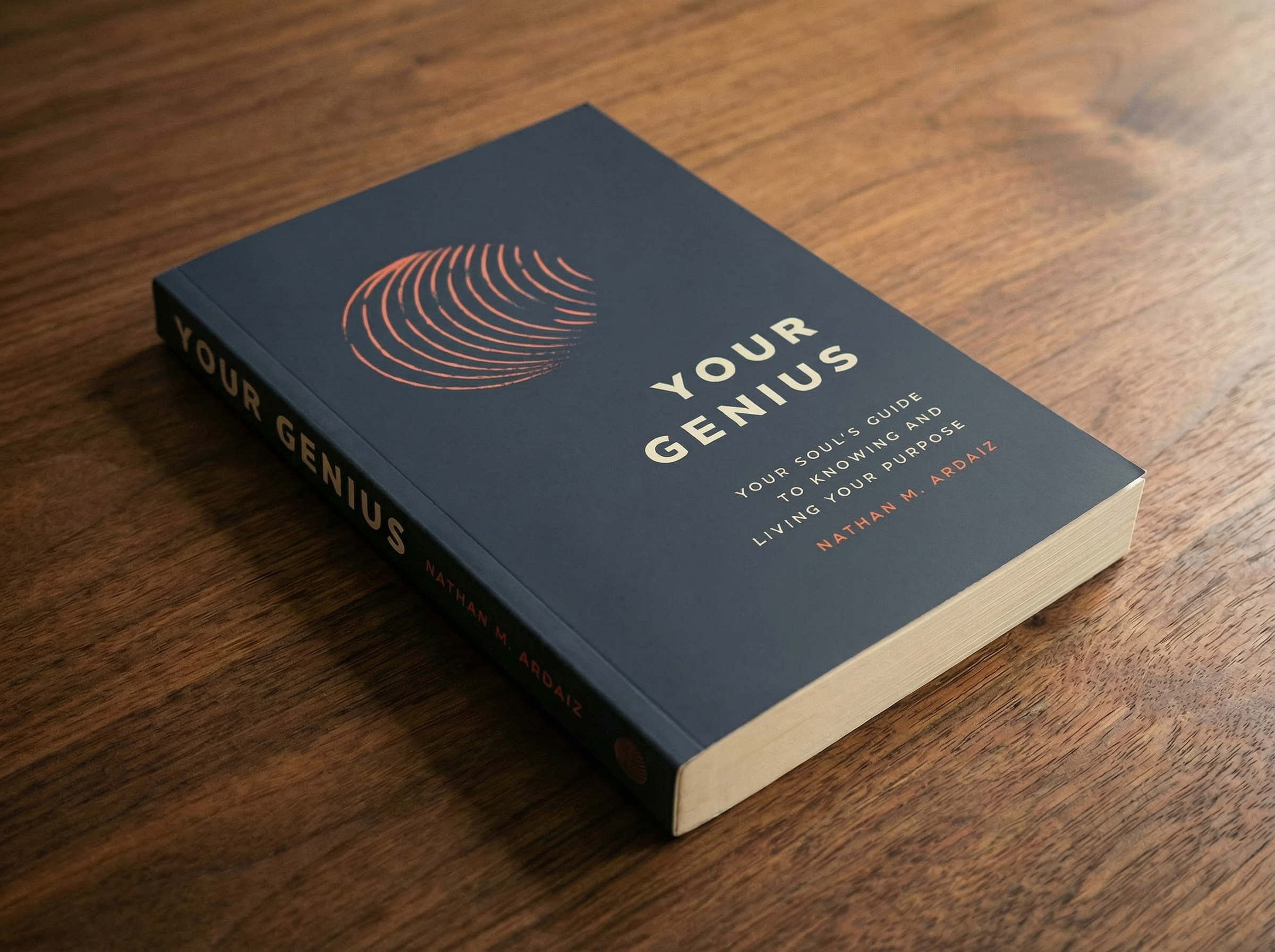 Your Genius, Your Soul's Guide to Knowing and Living Your Purpose book by Nathan M Ardaiz beautifuly designed paperback book on a dark wooden table