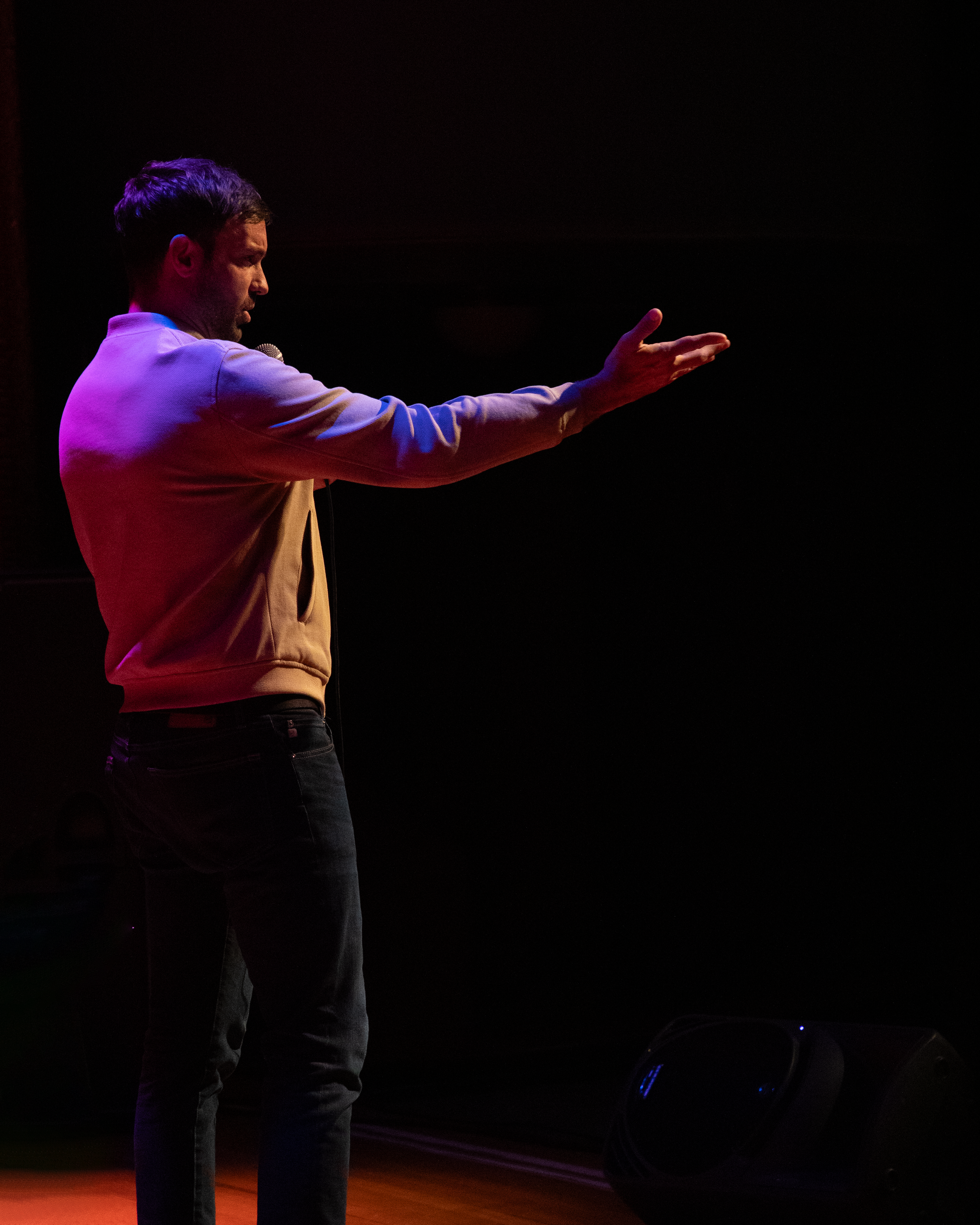 Side shot of comedian Jeff Dye performing a live event during his tour, The Last Cowboy in L.A.