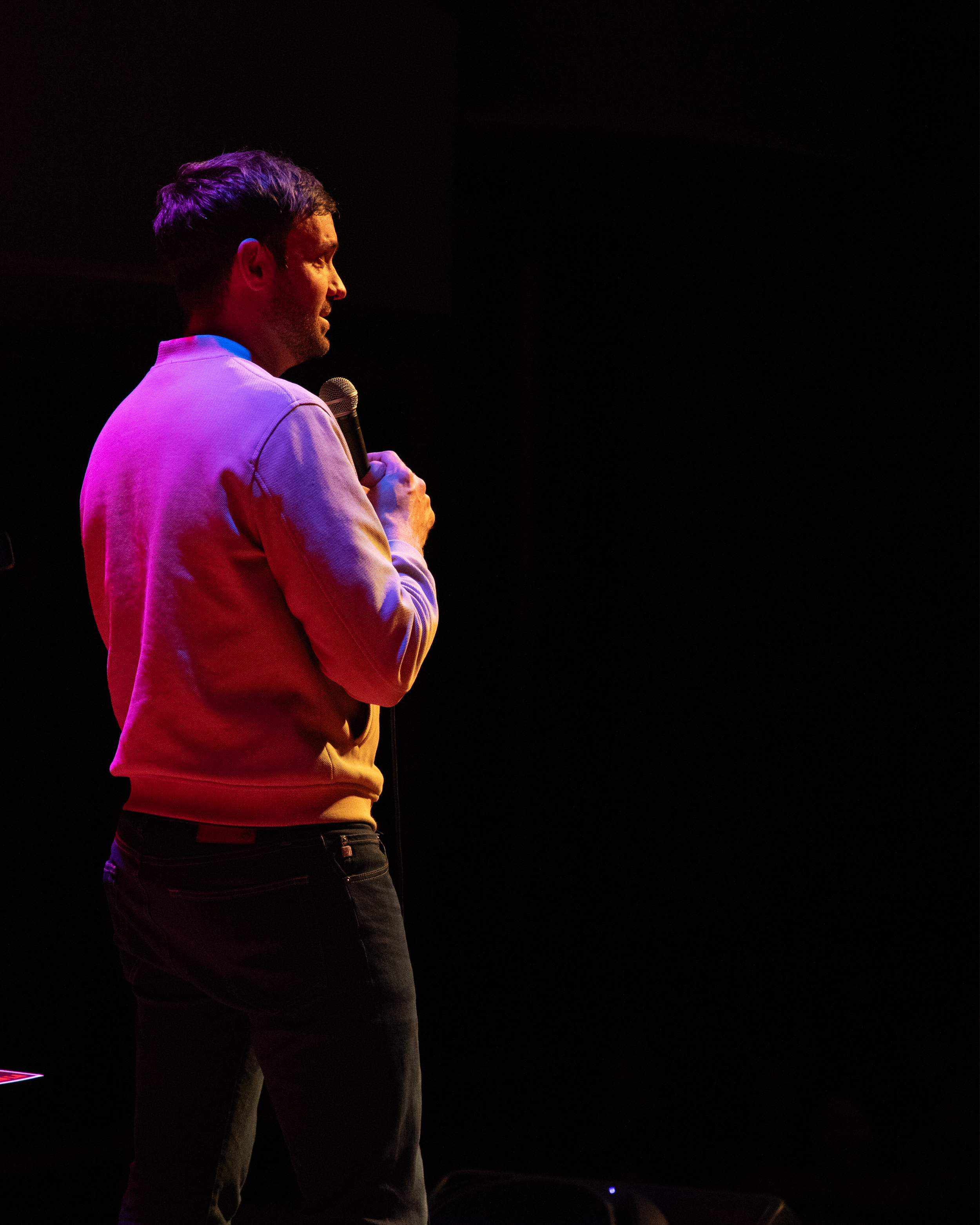 Side shot of comedian Jeff Dye performing a live event during his tour, The Last Cowboy in L.A.