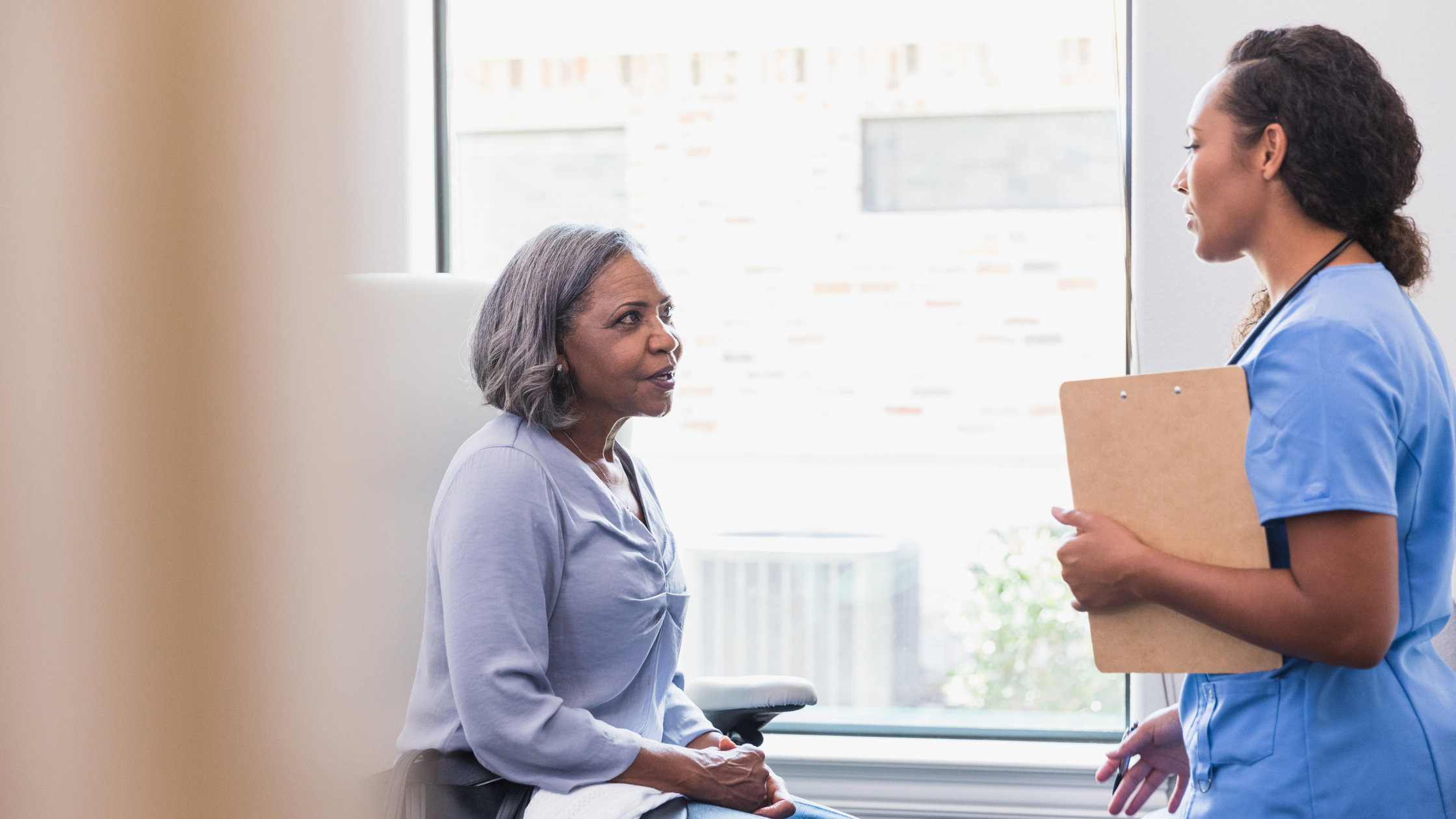 A healthcare provider speaks with one of her patients.