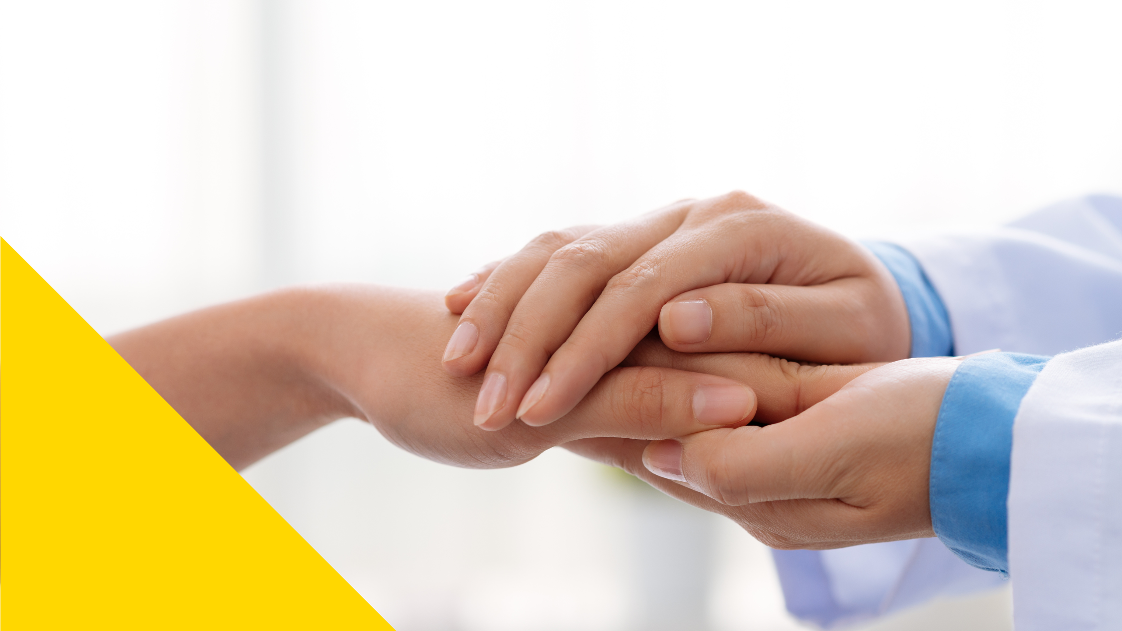 a doctor grasps their patient's hand