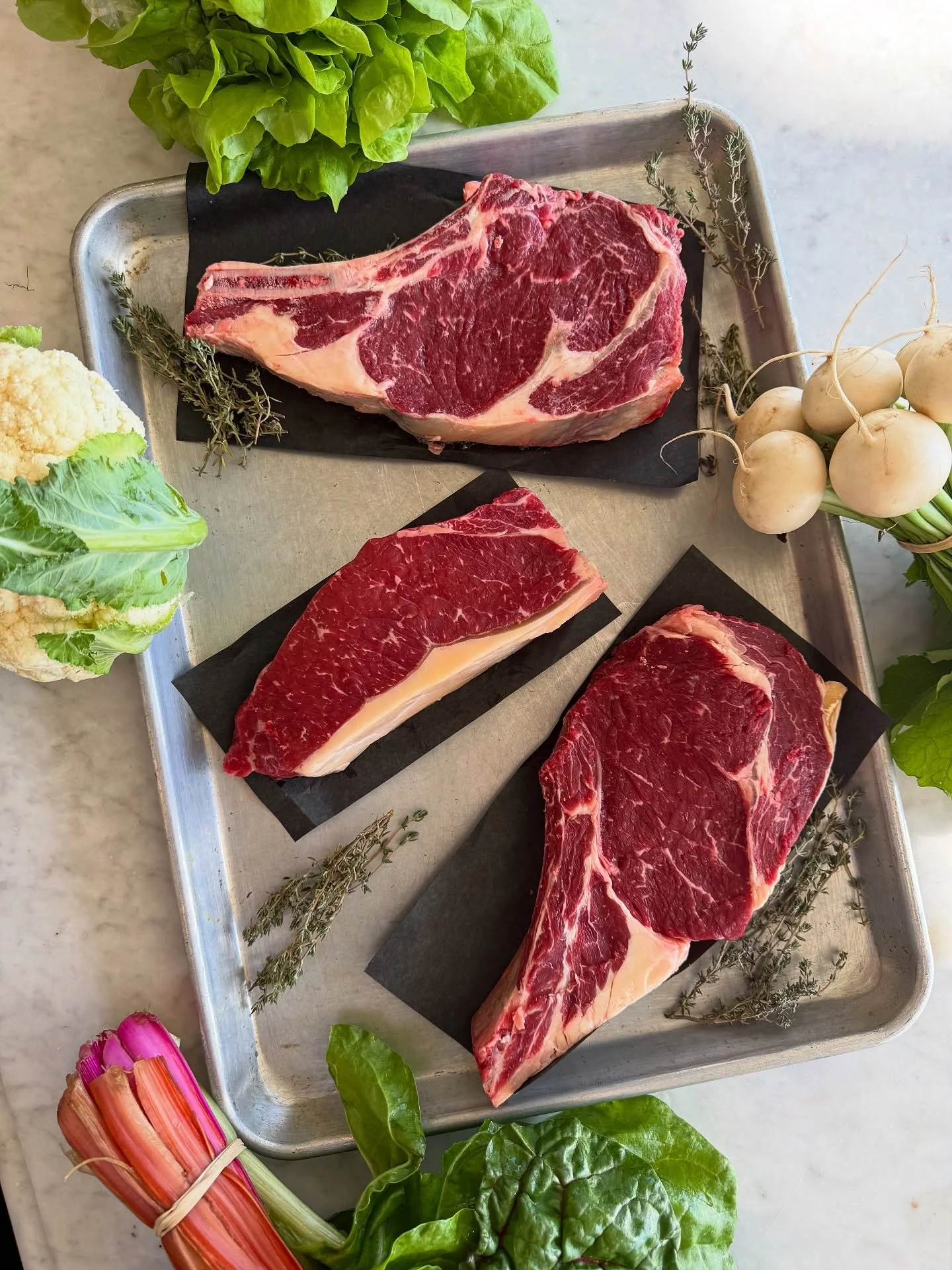 🥩 It&rsquo;s the weekend come shop! 🥩

Grass-fed and finished NY strips and bone-in ribeyes from @homeplacepastures are back in stock! Nothing compares to the taste of local pastured beef!

@nativeson.farm also delivered chard, lettuces, radishes, 